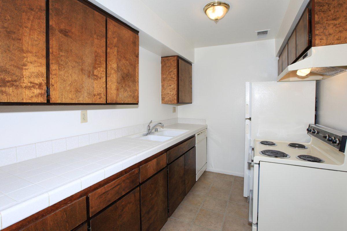 a kitchen with a stove sink and refrigerator