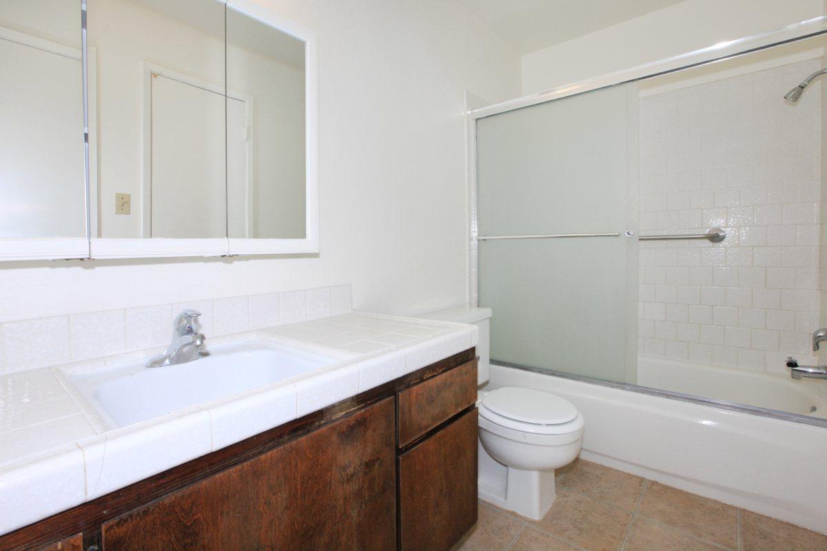 a white tub sitting next to a sink