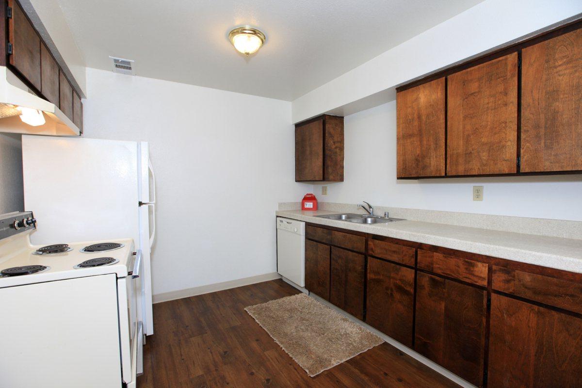 a kitchen with a stove sink and refrigerator