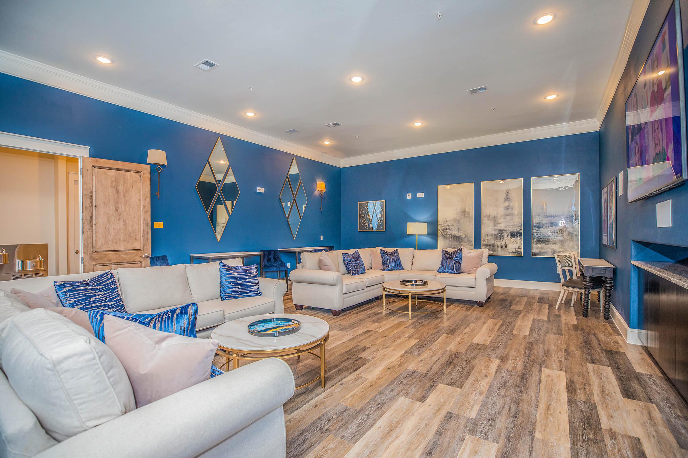 a living room filled with furniture and a large window