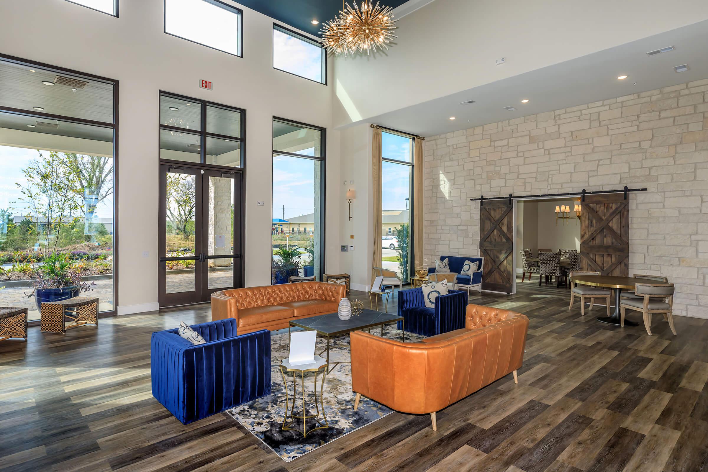 a living room filled with furniture and a large window