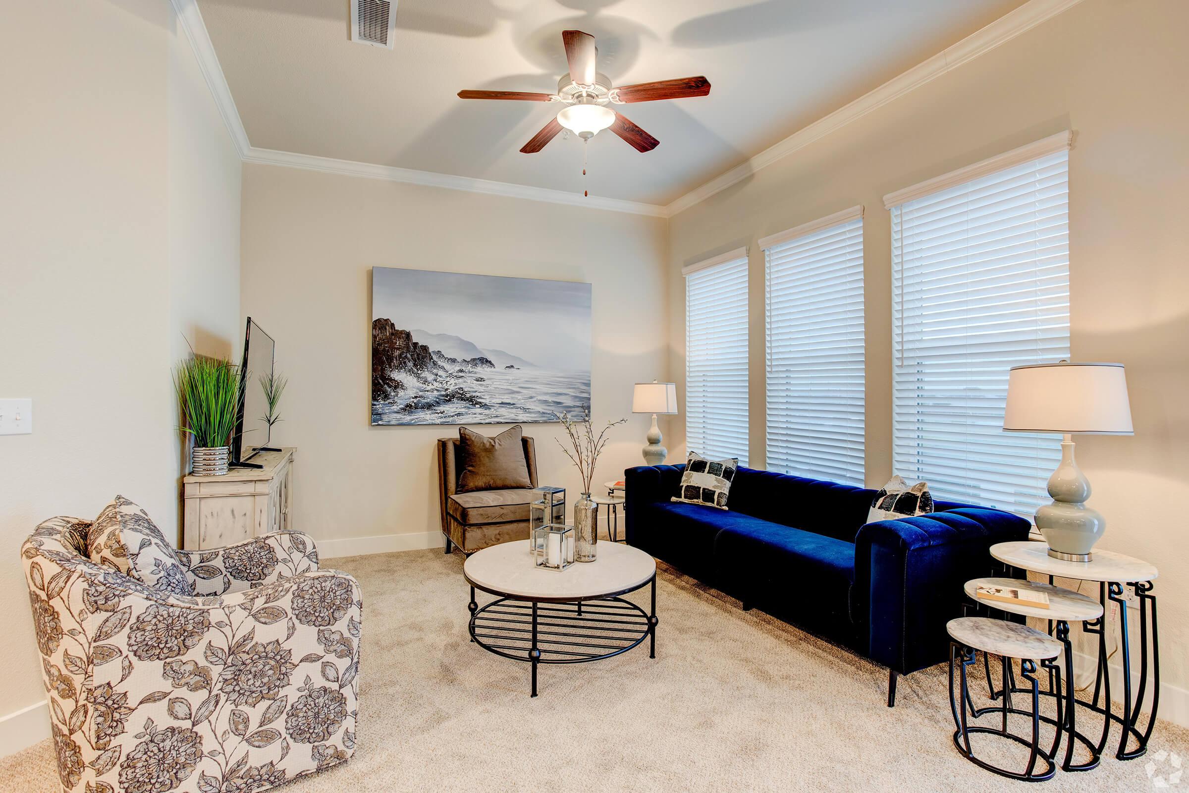 a living room filled with furniture and a large window