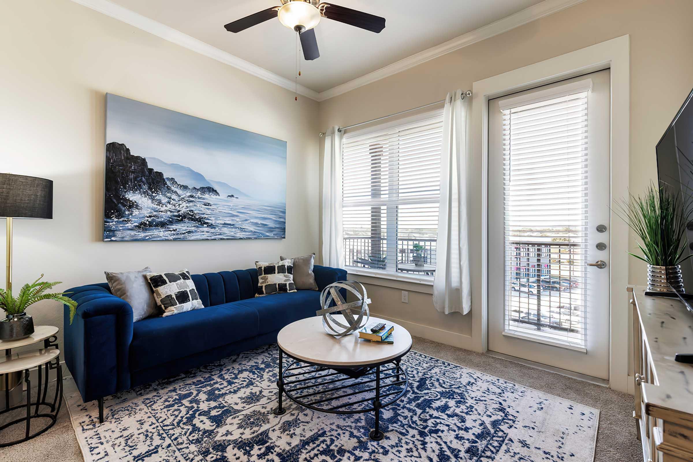 a living room filled with furniture and a large window