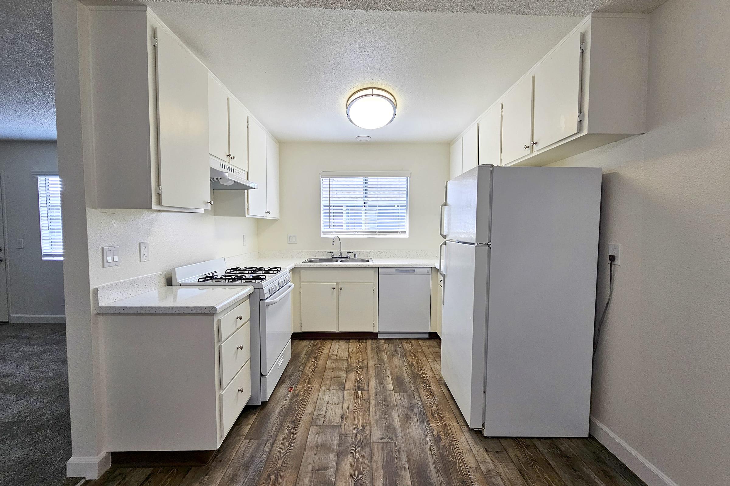 a kitchen with a sink and a refrigerator