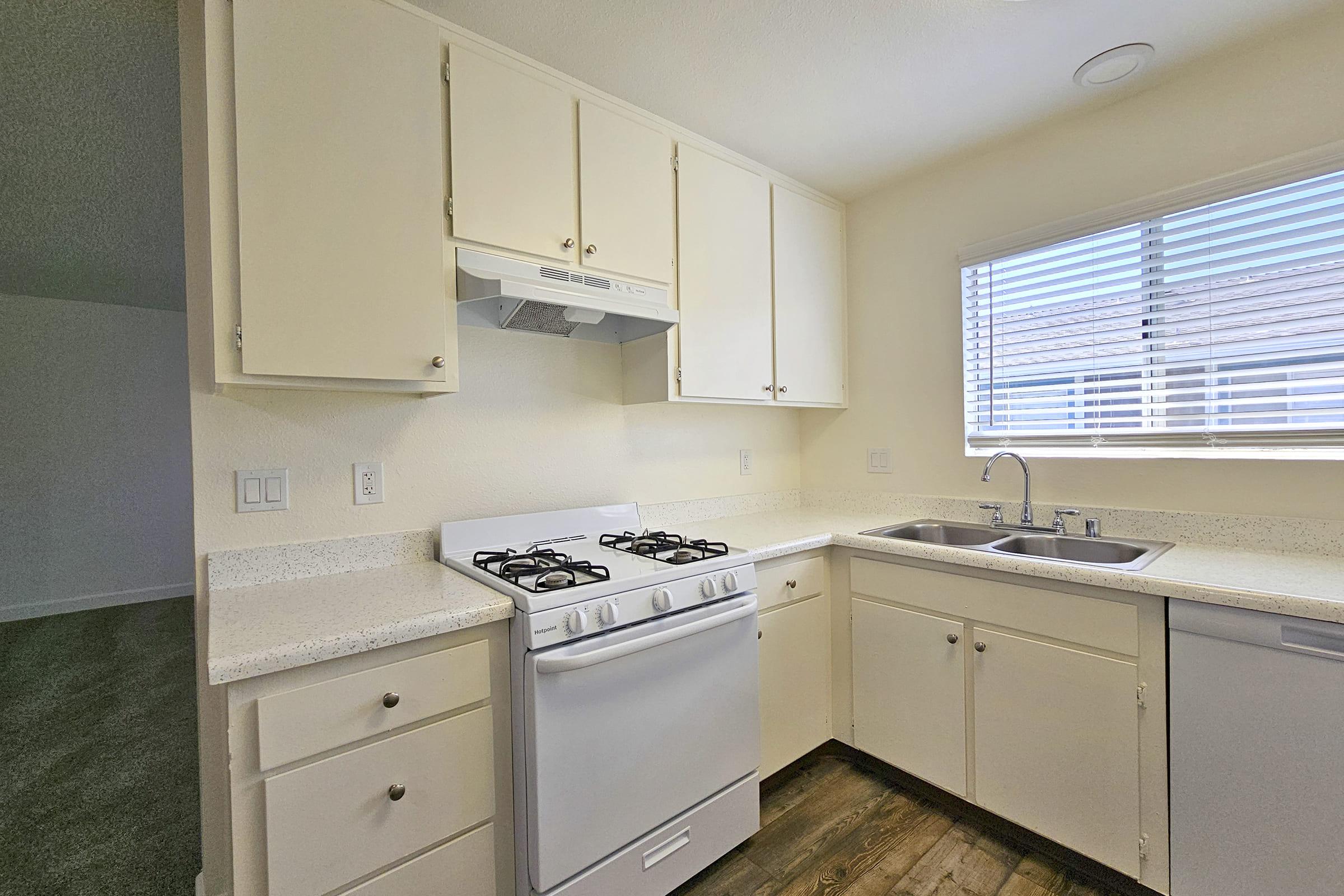 a kitchen with a stove and a sink