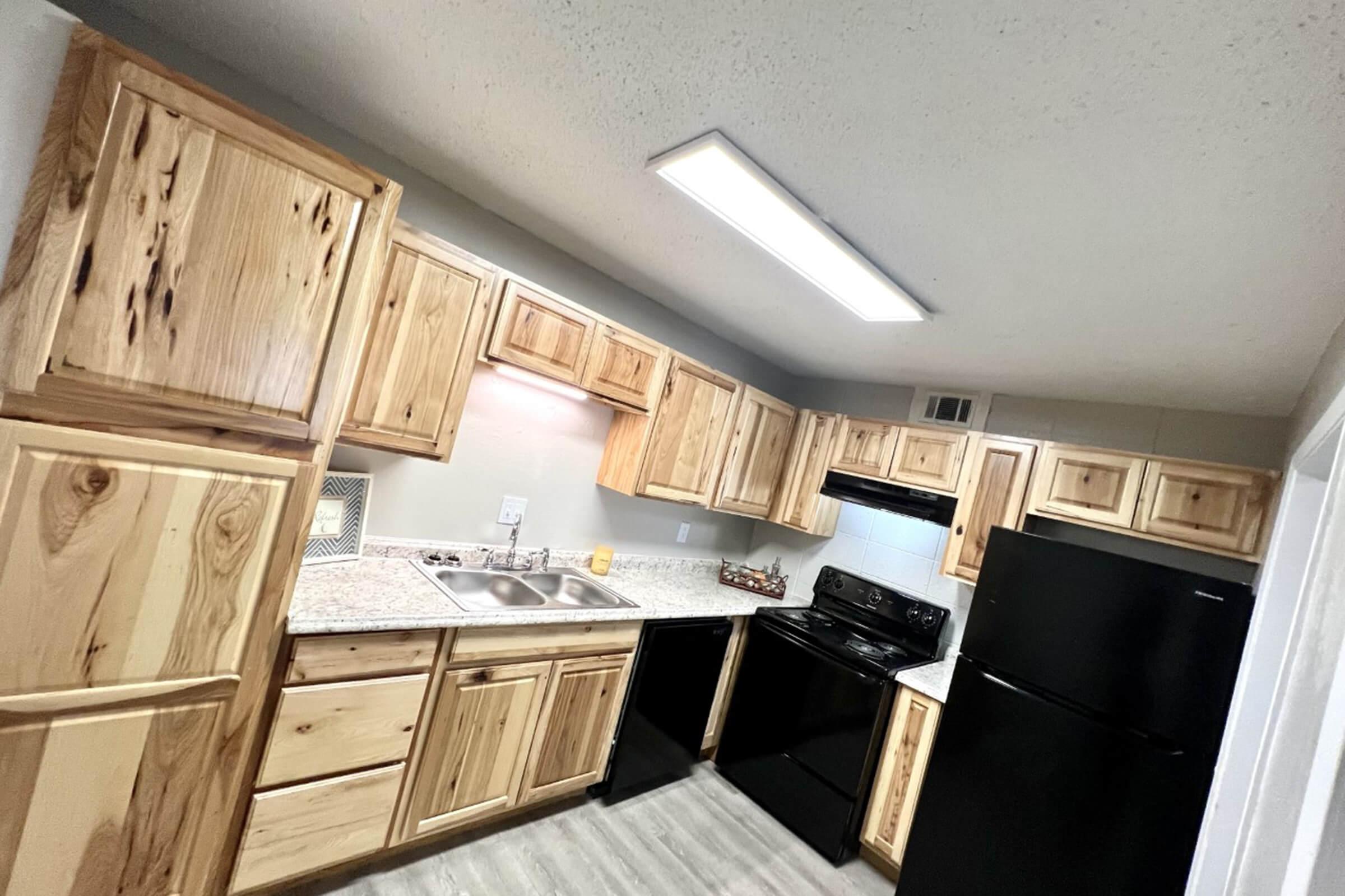 a kitchen with stainless steel appliances and wooden cabinets