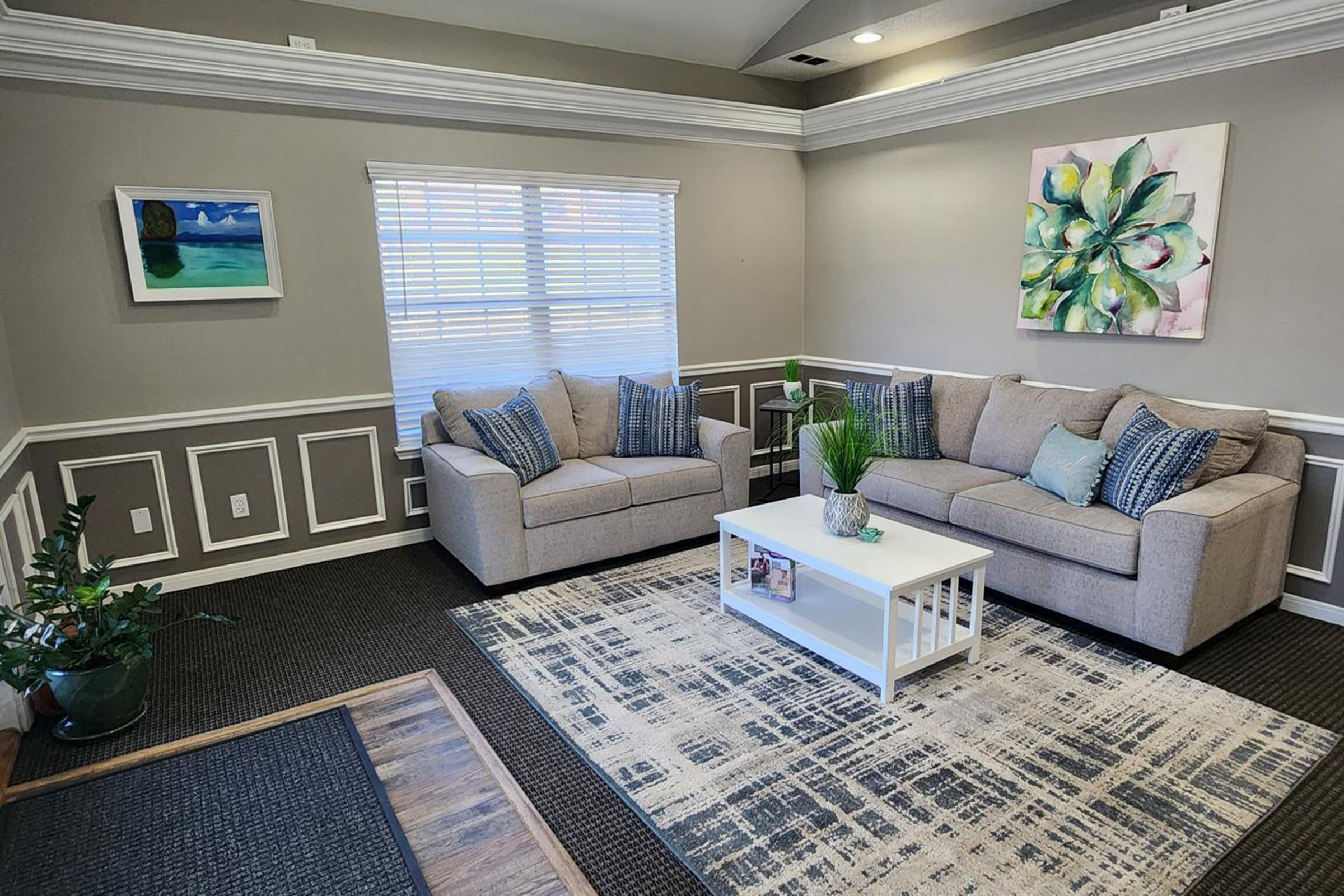 a living room filled with furniture and a large window