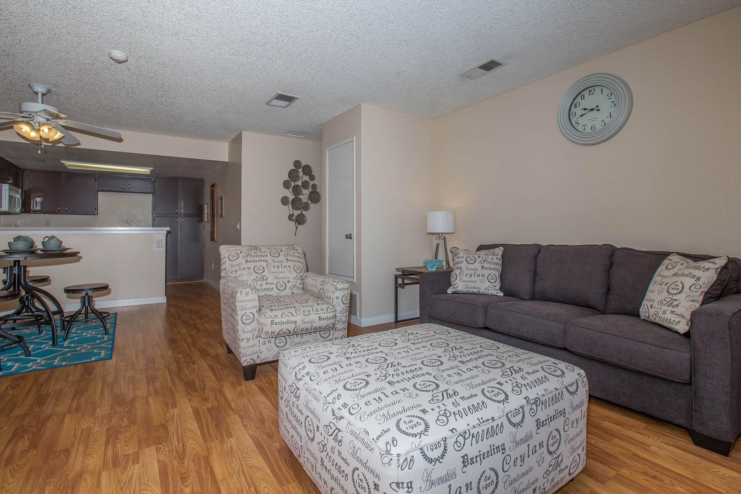 a living room filled with furniture and a rug
