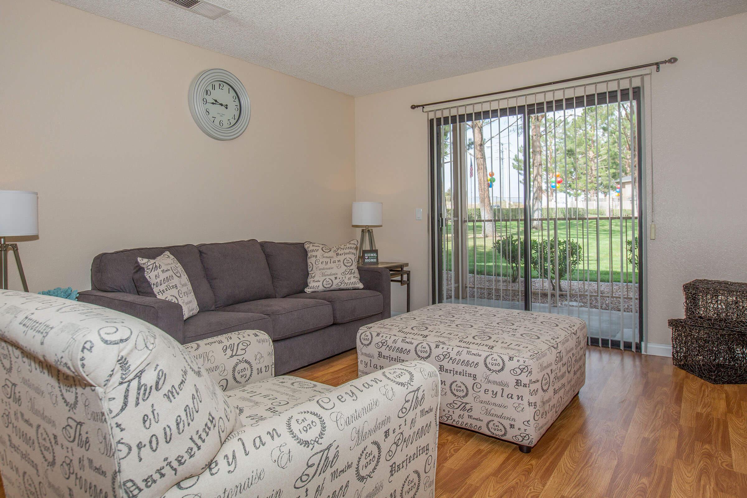 a living room filled with furniture and a large window