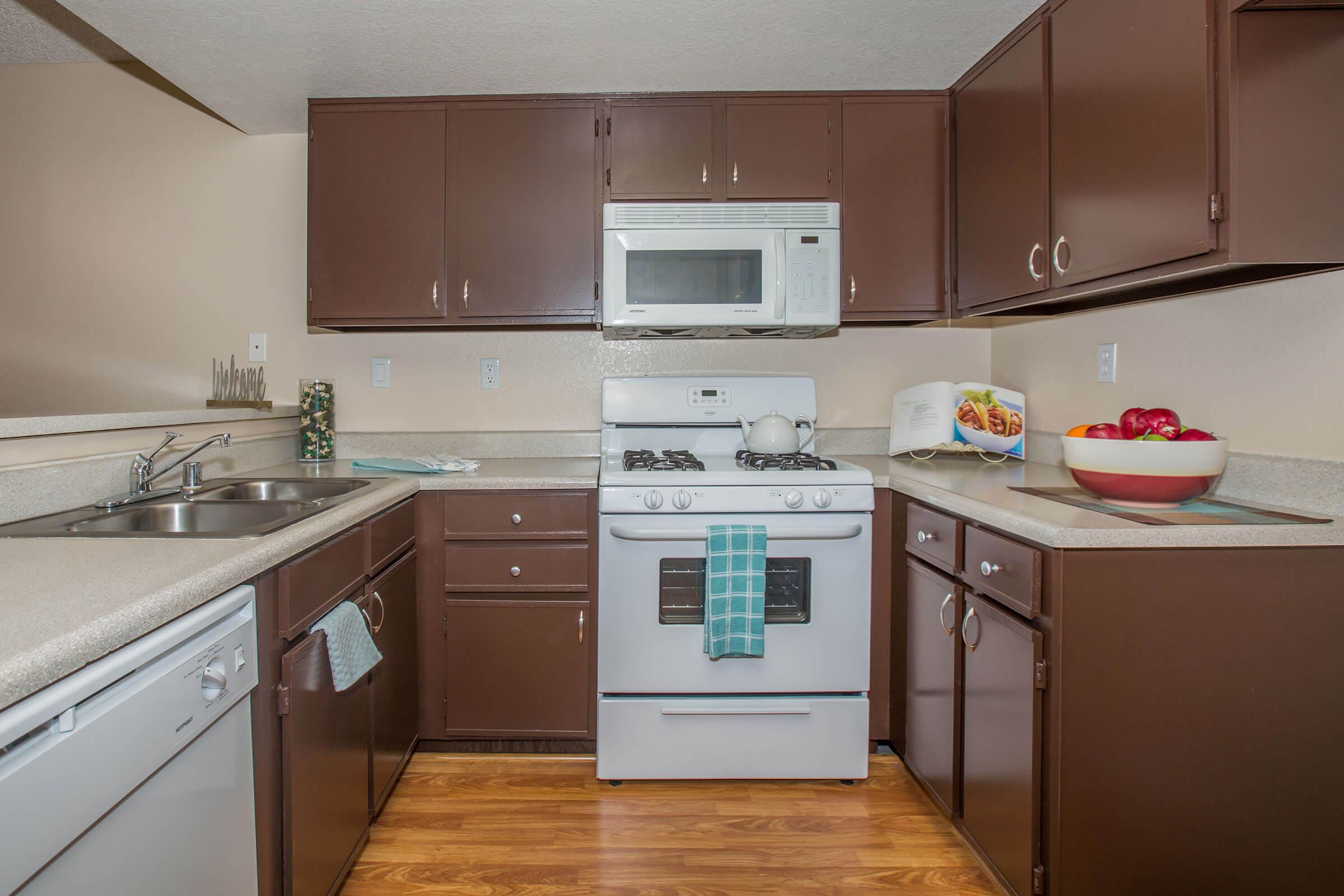 a kitchen with a stove a sink and a microwave