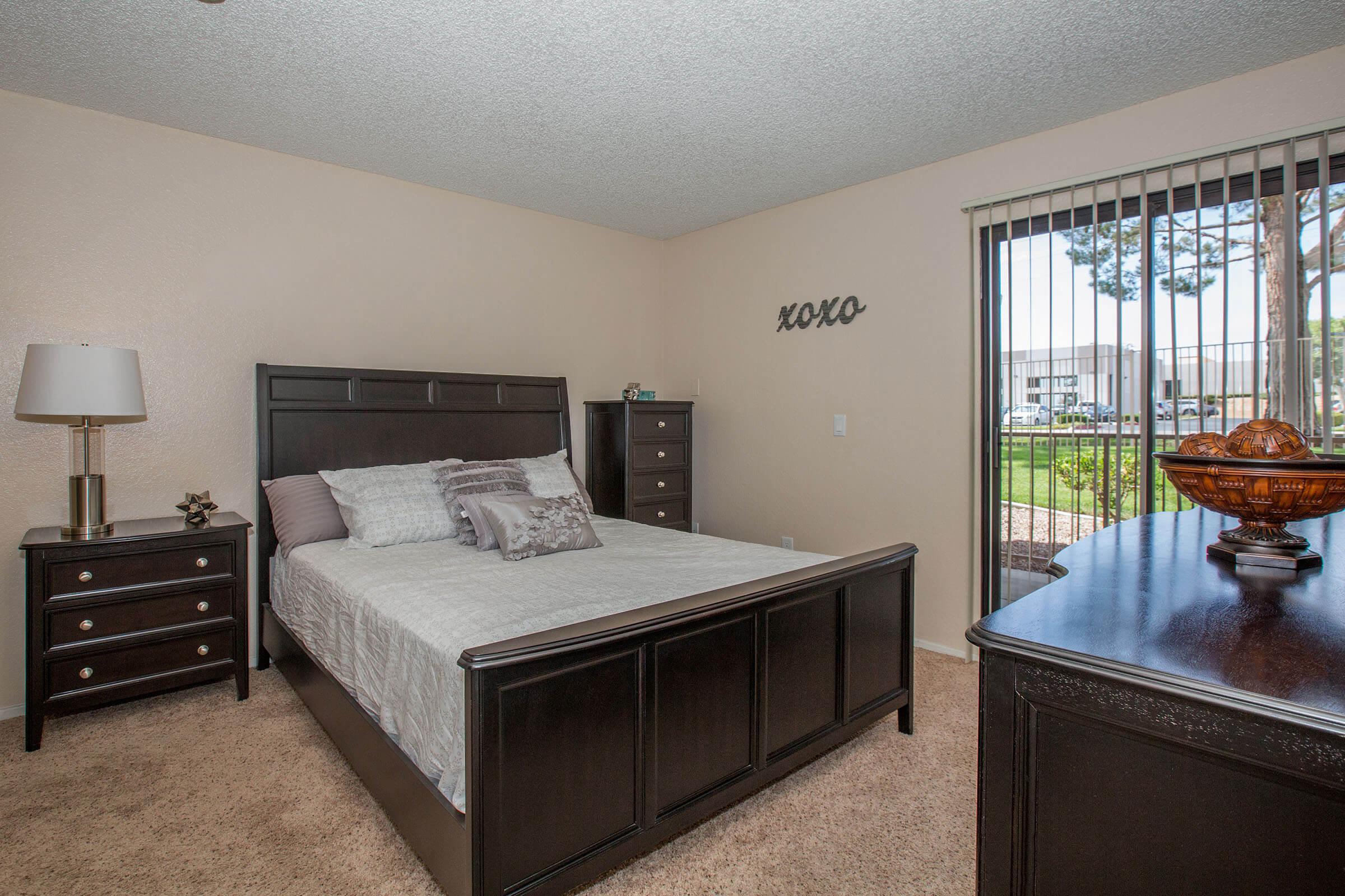 a bedroom with a bed and desk in a room