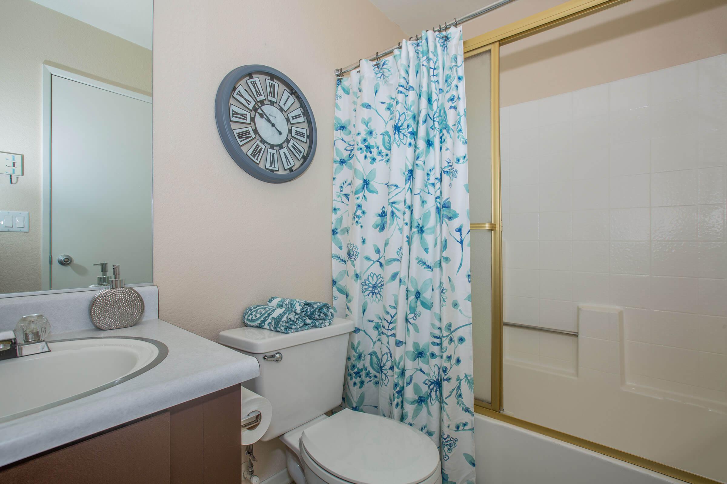 a bedroom with a shower and a sink