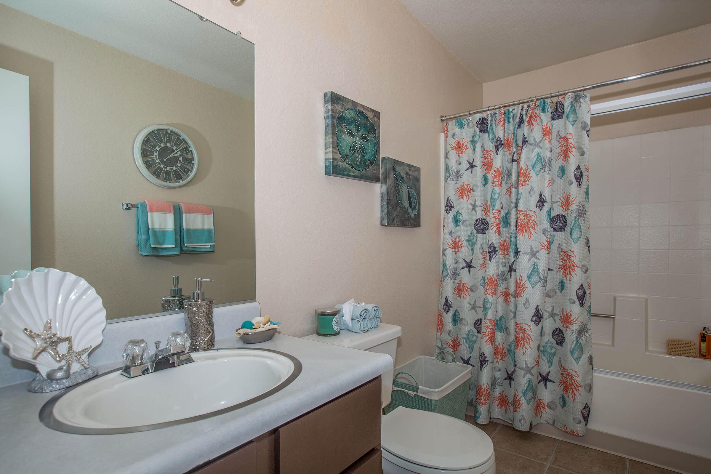 a room with a sink and a mirror