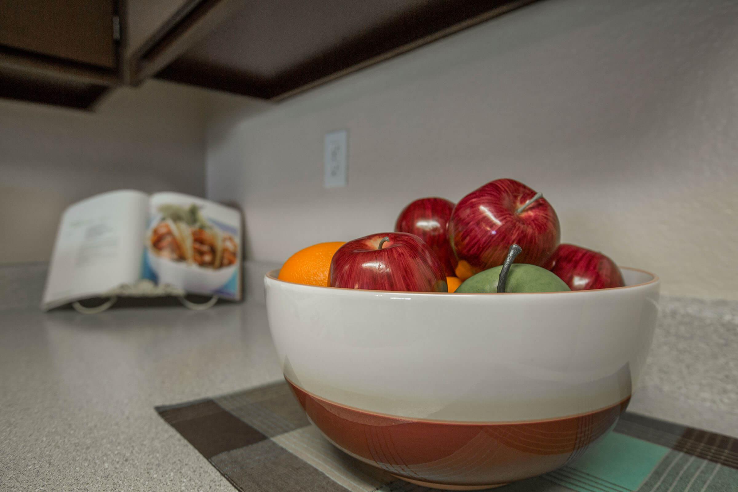 a bowl of fruit sitting on a table