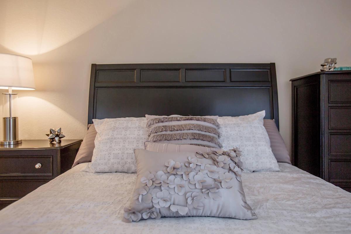 a large white bed in a bedroom