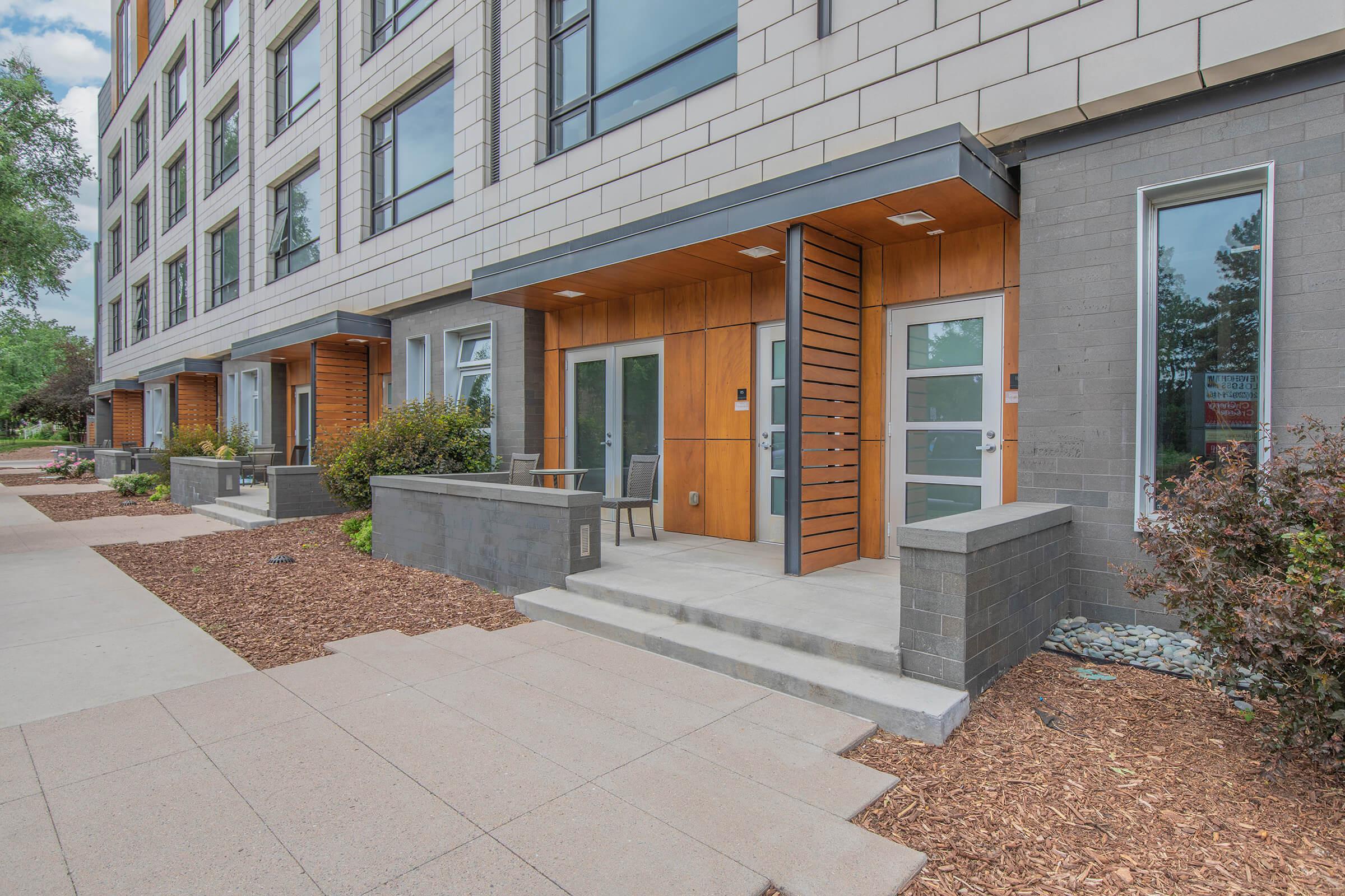 a bench in front of a brick building