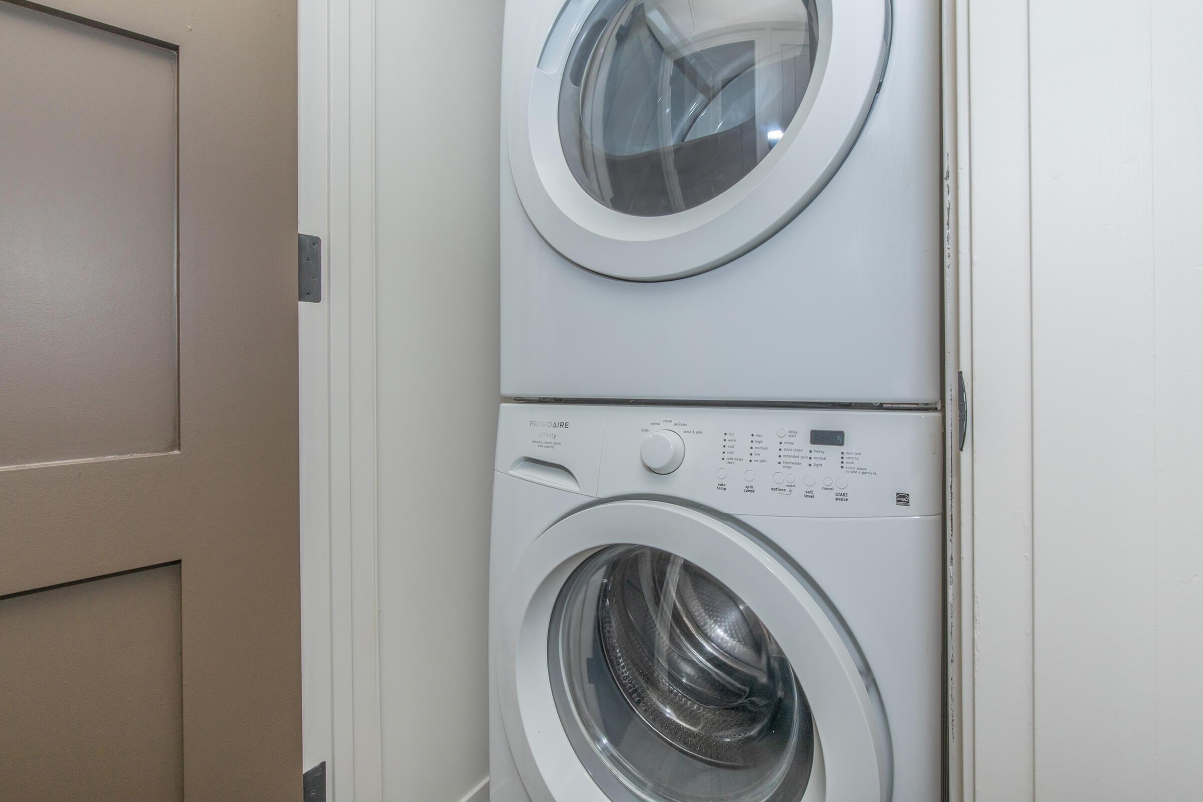 a washer in front of a mirror posing for the camera