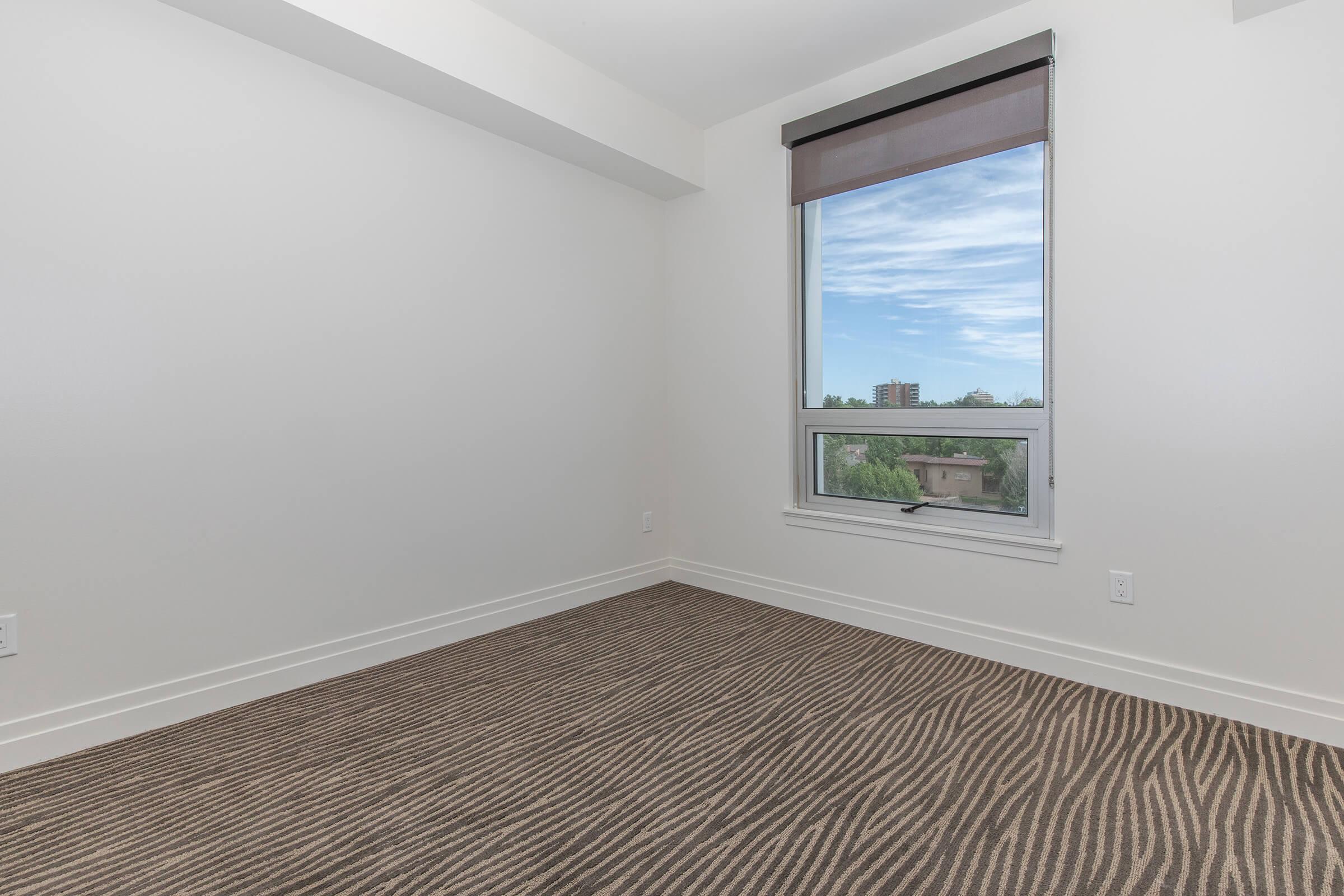 a bedroom with a large window