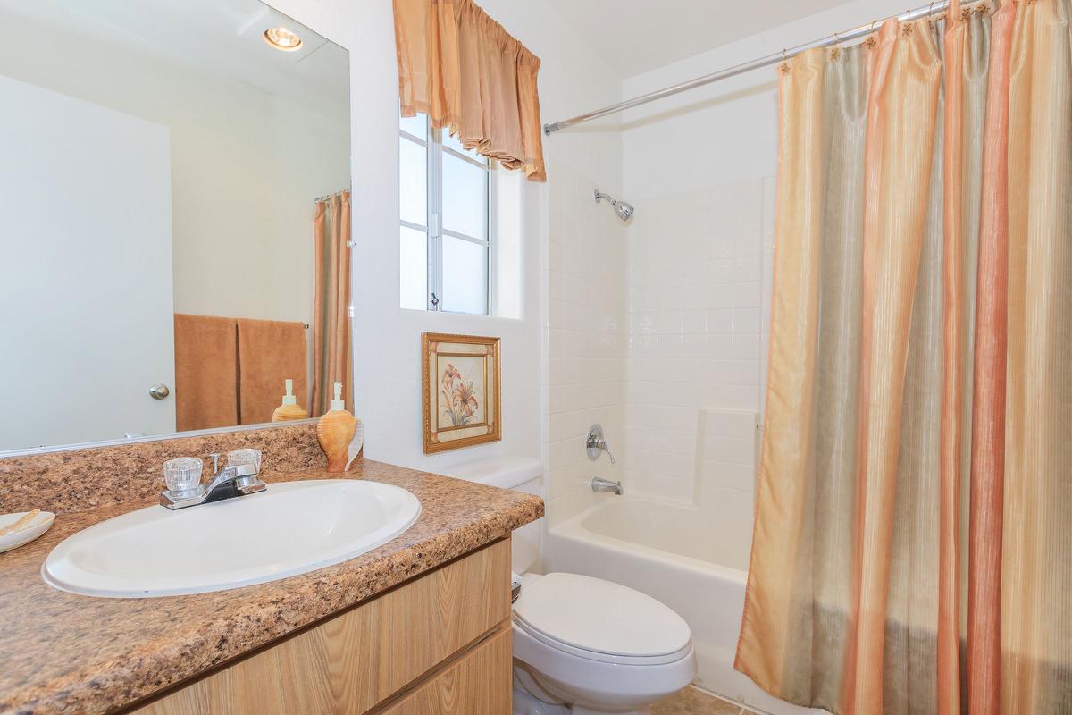 a large white tub next to a shower curtain
