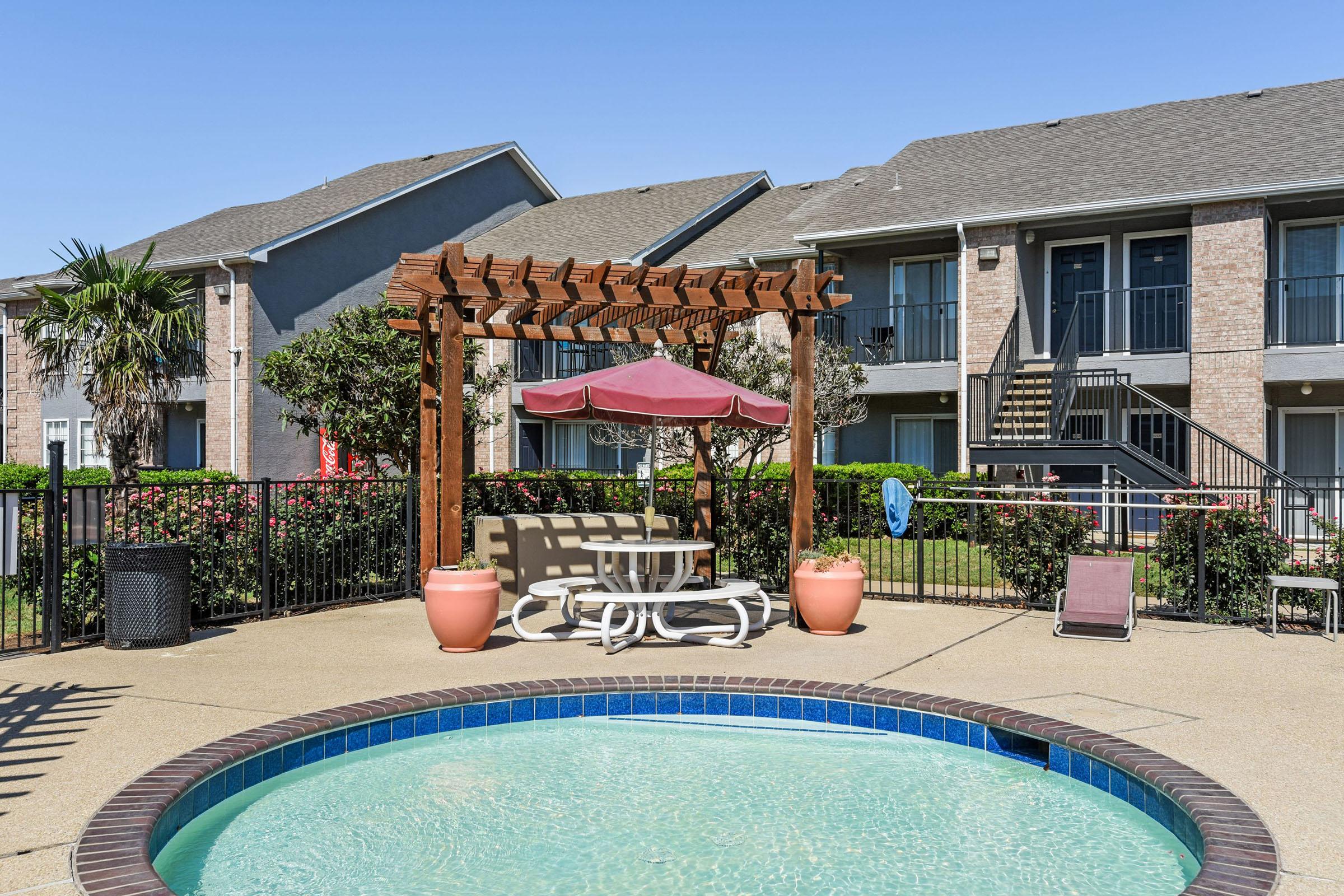 a house with a pool in front of a building