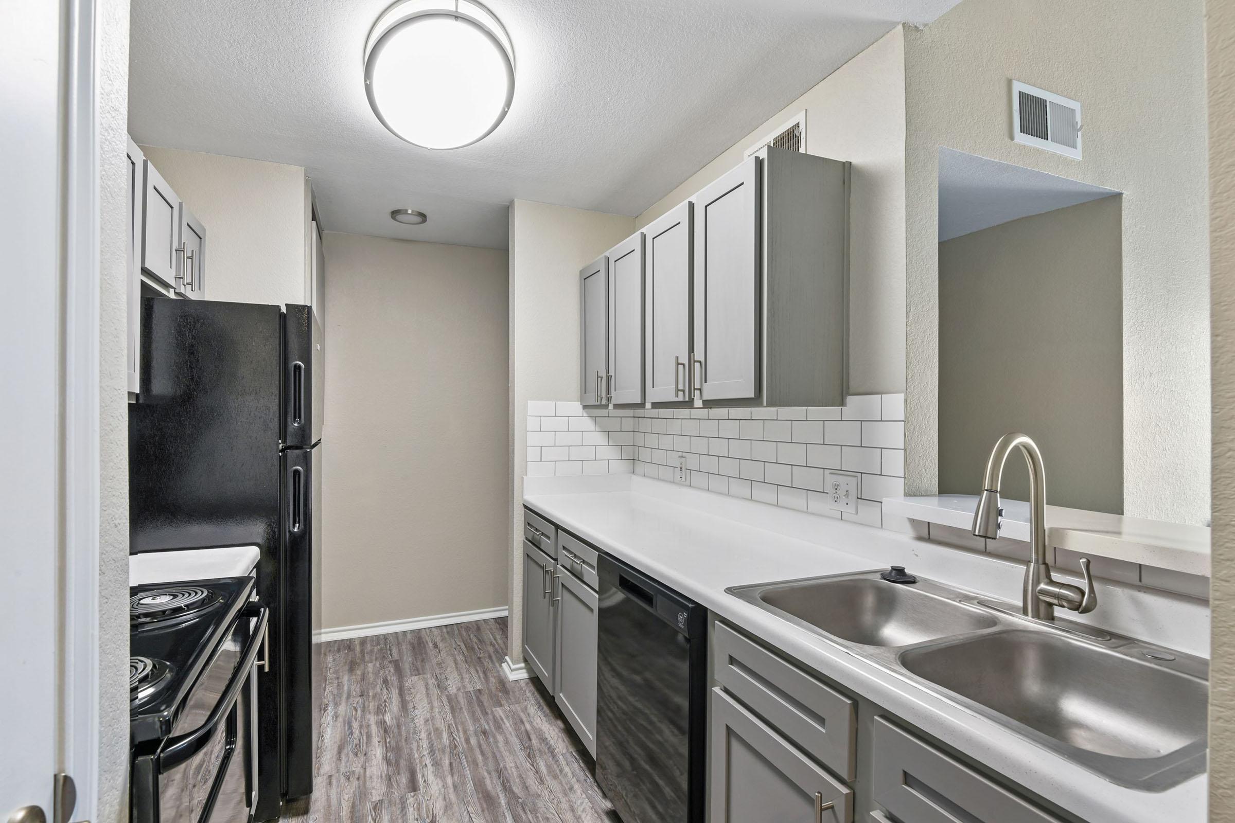 a kitchen with a sink and a mirror