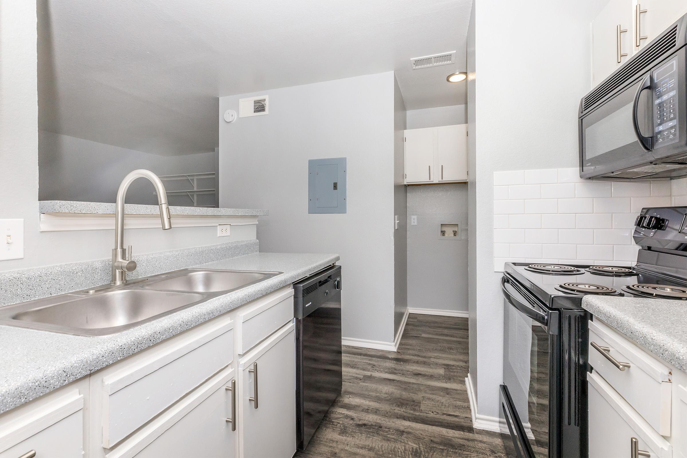 a kitchen with a stove sink and refrigerator