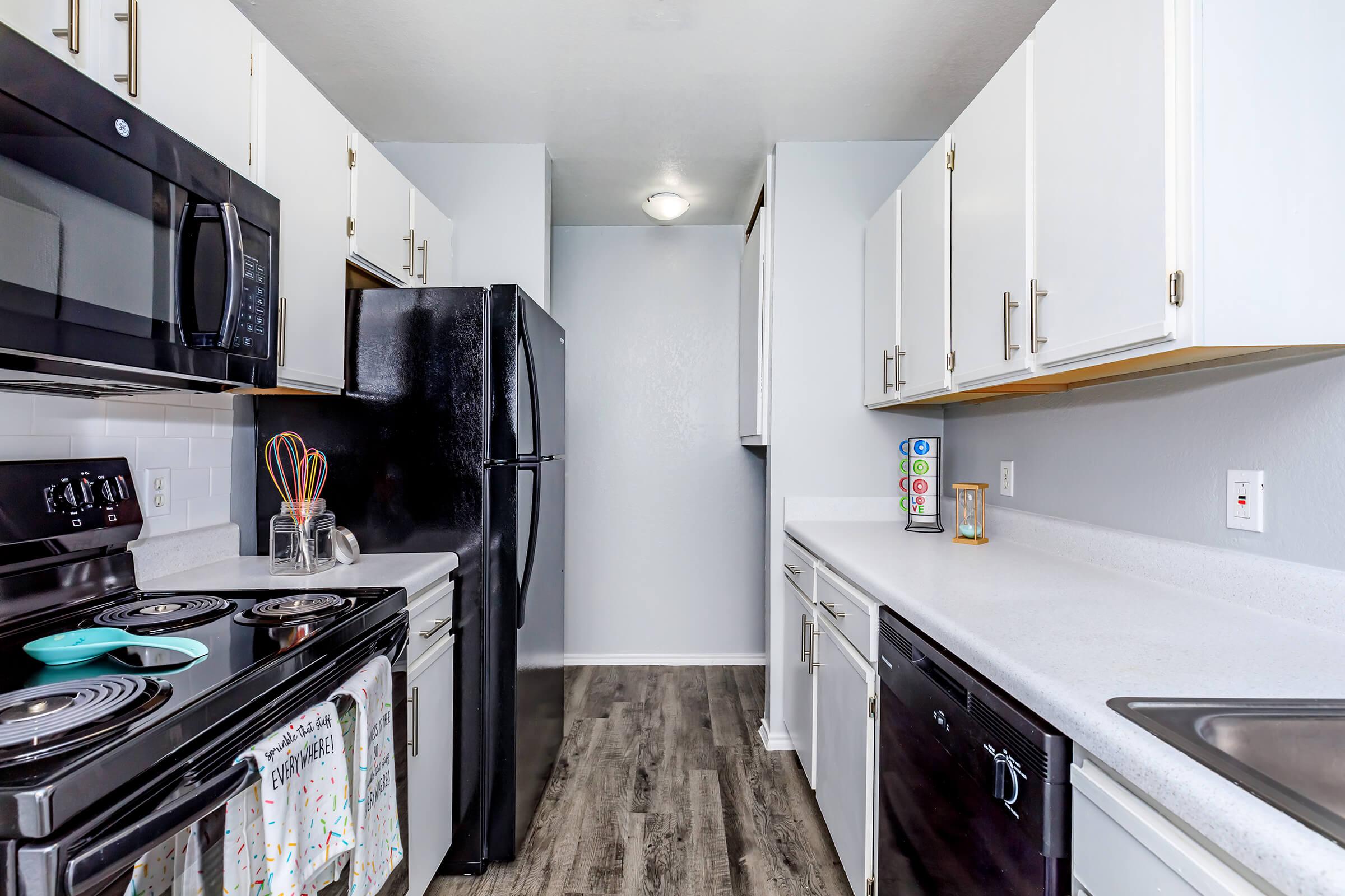 a kitchen with a stove sink and refrigerator