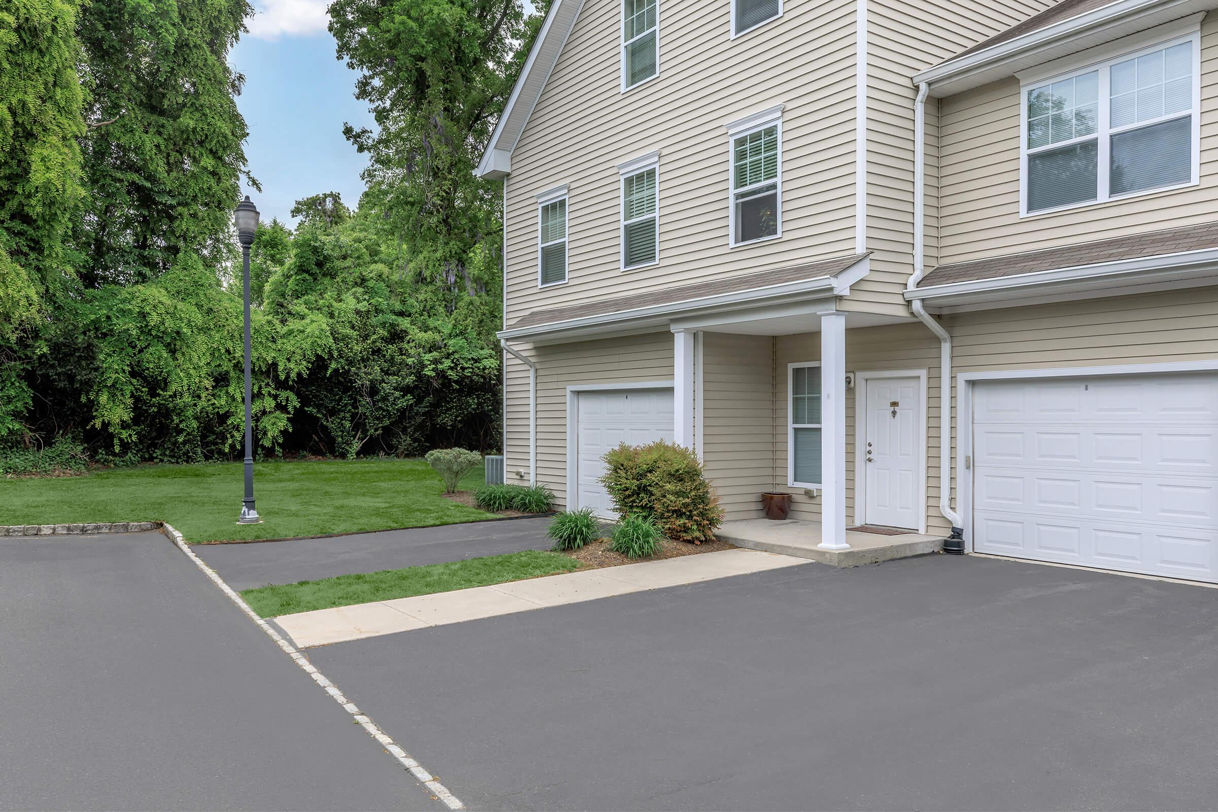 an empty parking lot in front of a house