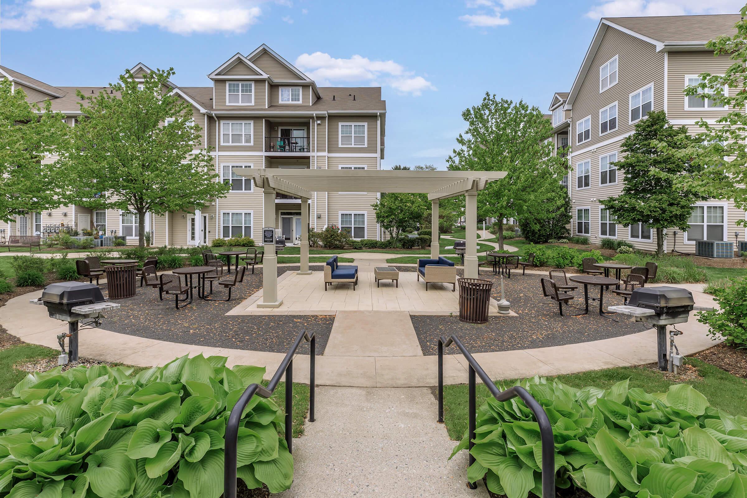 Long Branch, NJ Pet-Friendly Apartments - The Village at West Long Branch - Courtyard with a Gazebo, Grilling Station, and Trees