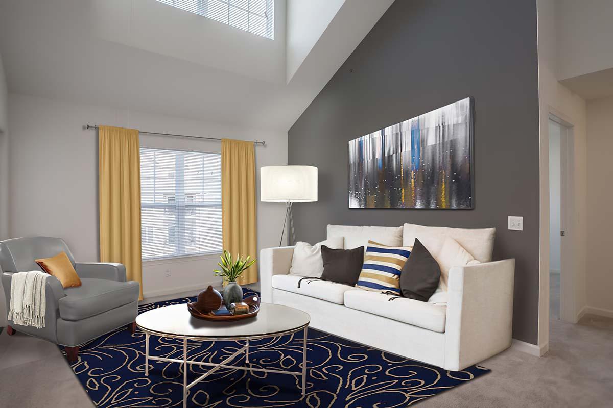 Apartments in Long Branch, NJ - The Village at West Long Branch - Living Room with High Ceilings, Carpeting through Interior, and Wall Art