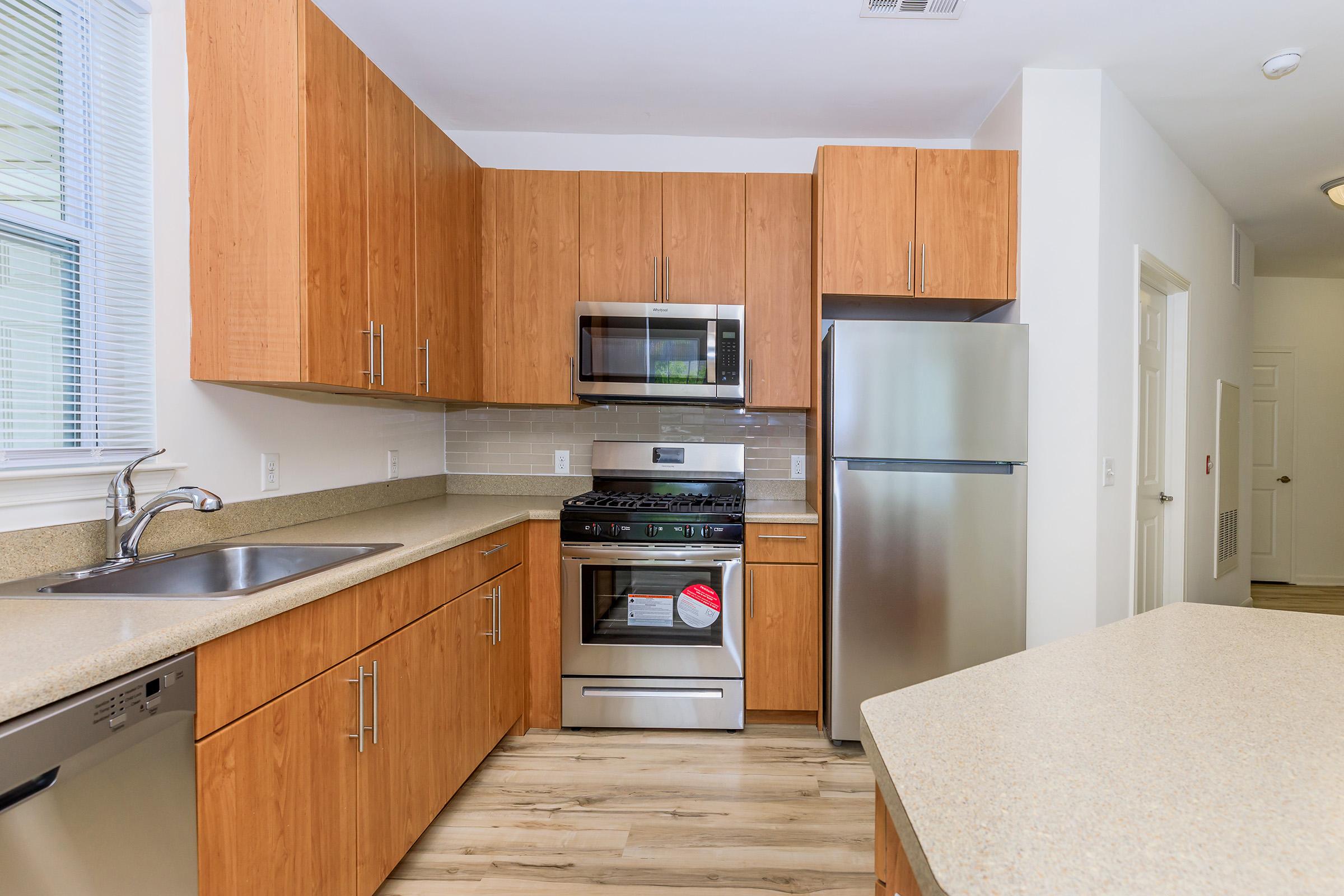 a kitchen with stainless steel appliances and wooden cabinets