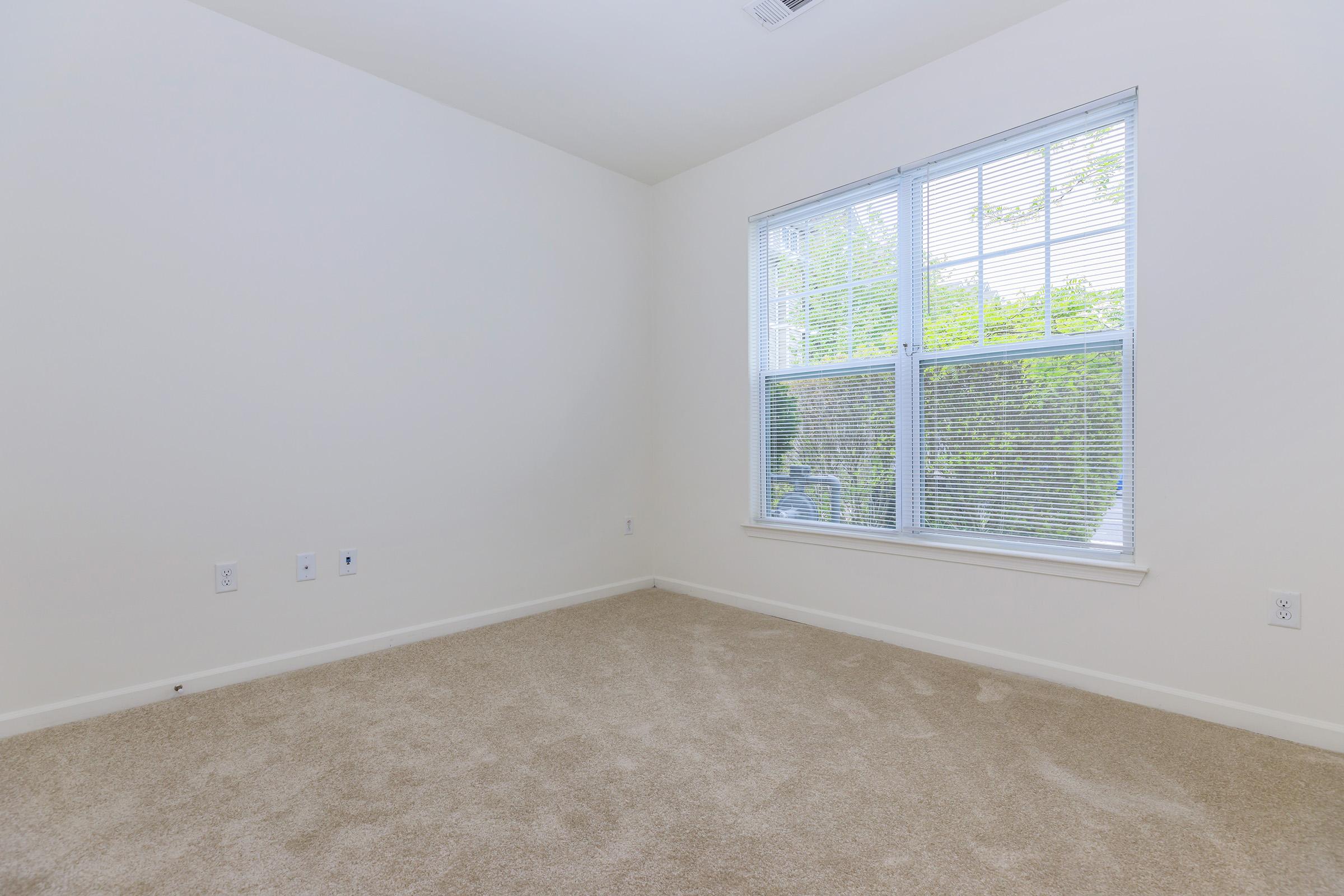 a bedroom with a large window