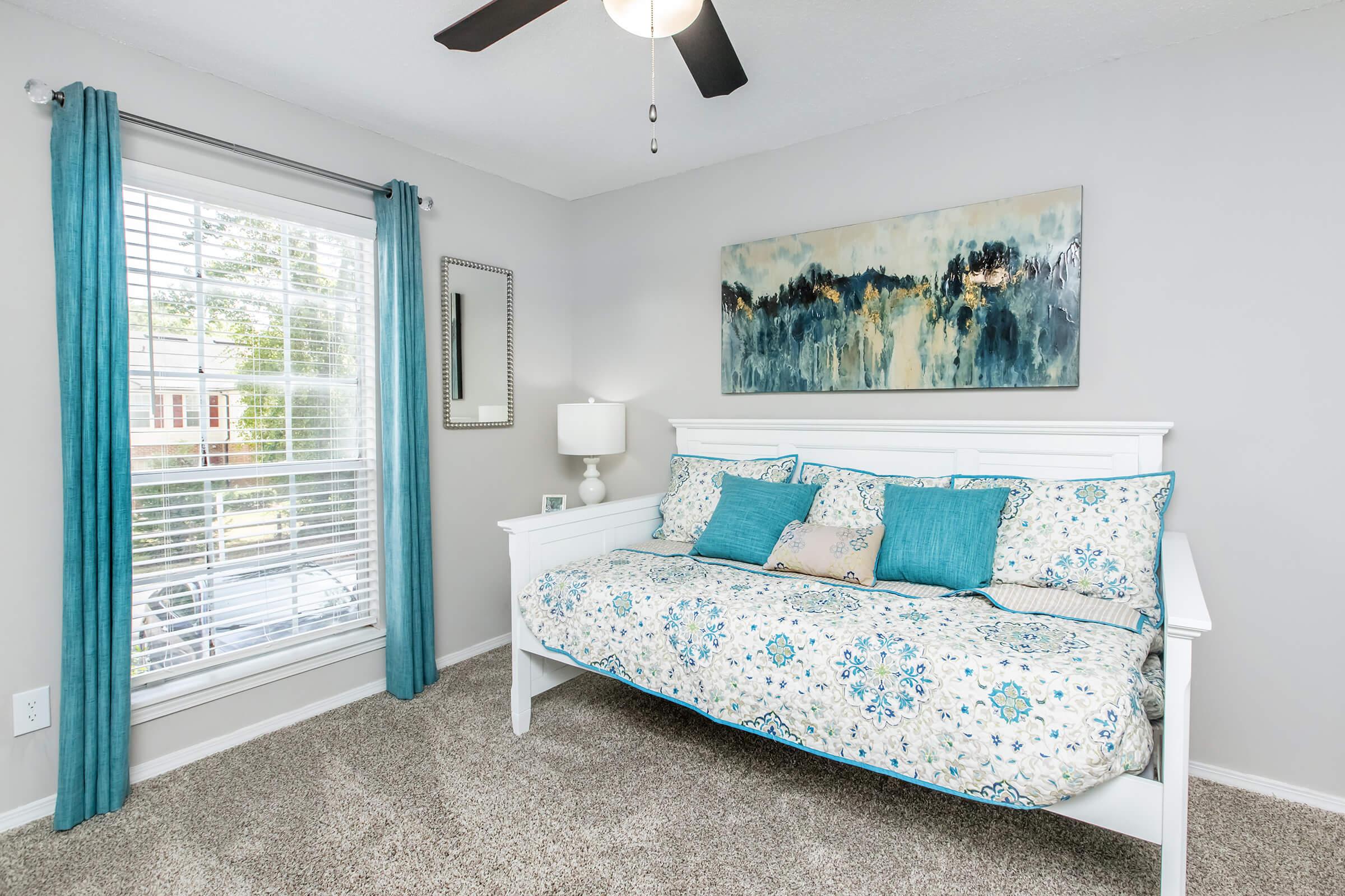 a bedroom with a bed in a room