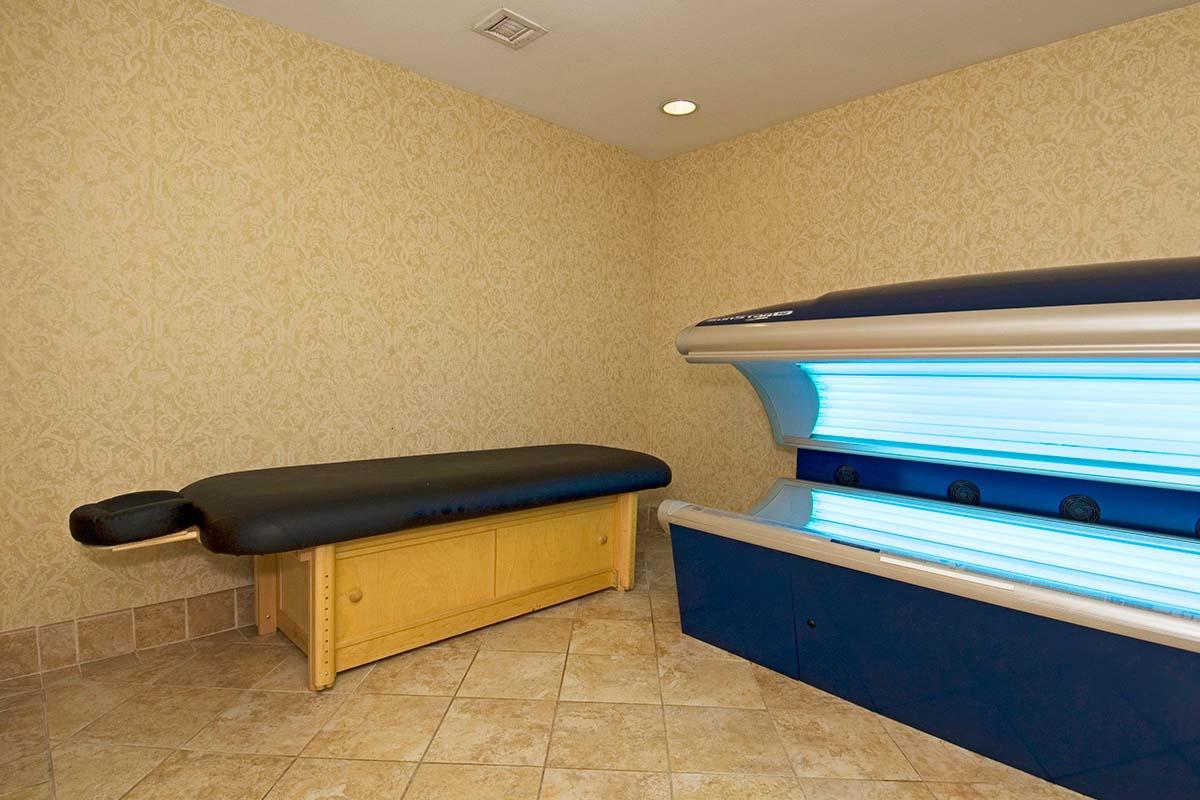 a bedroom with a bed and desk in a room