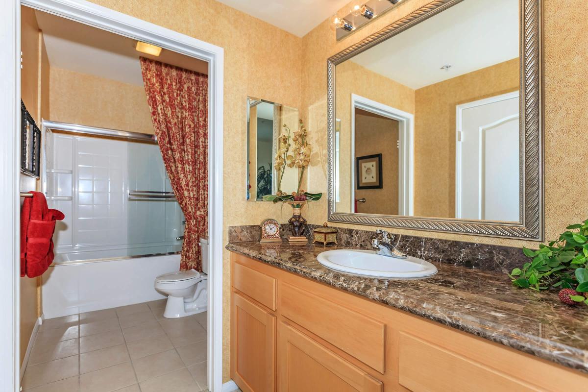 a kitchen with a sink and a mirror