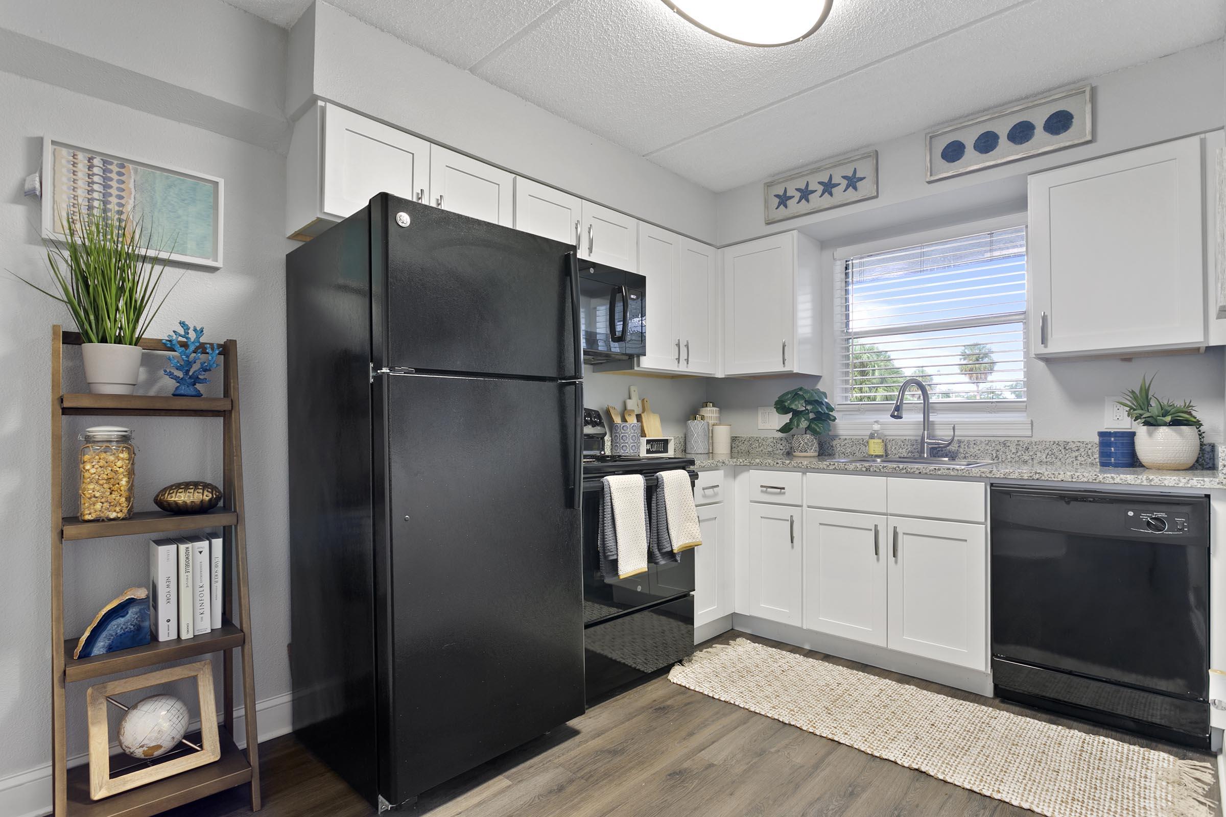 a kitchen with a sink and a refrigerator