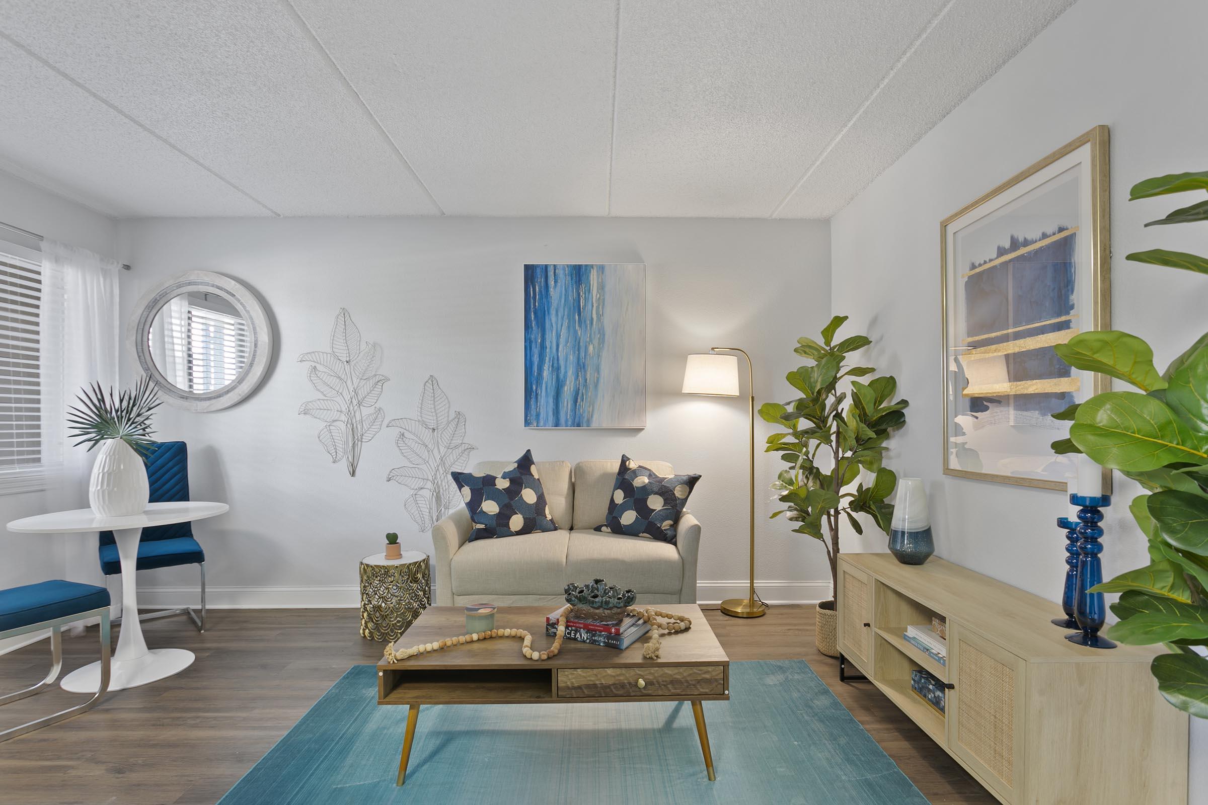 a living room filled with furniture and a large window