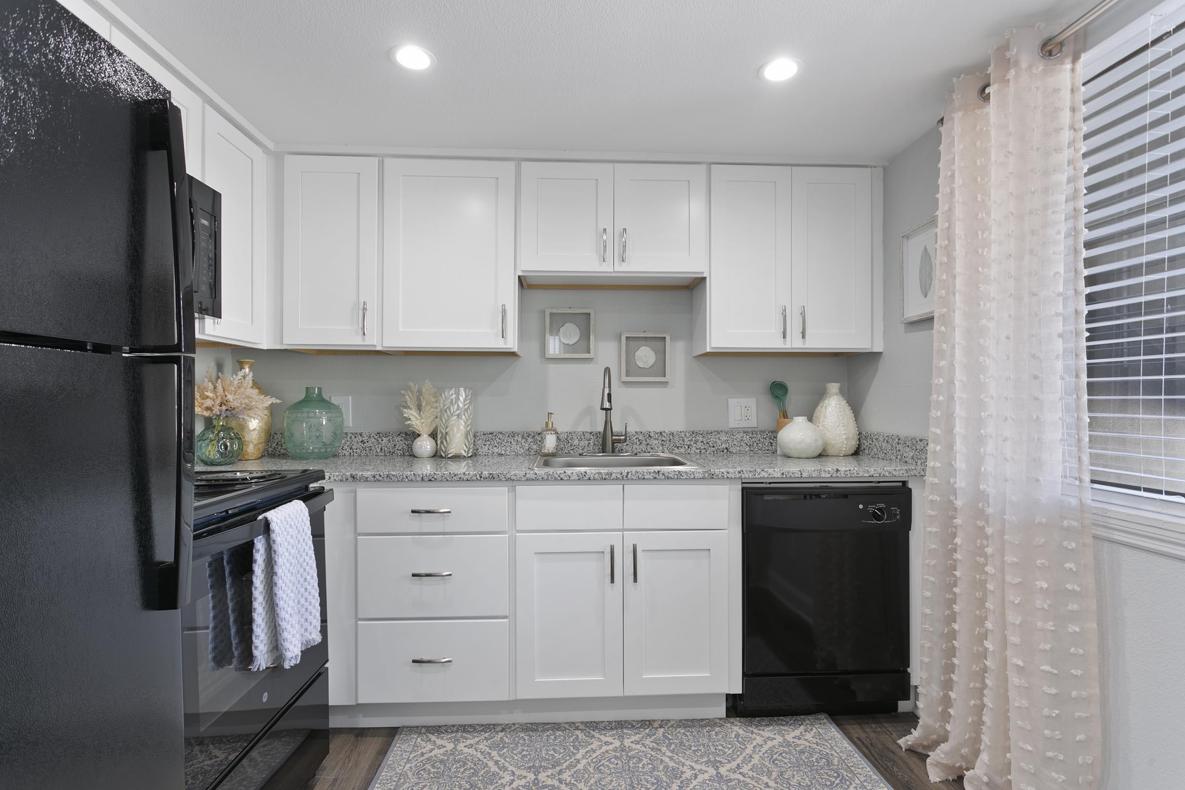 a kitchen with a sink and a refrigerator