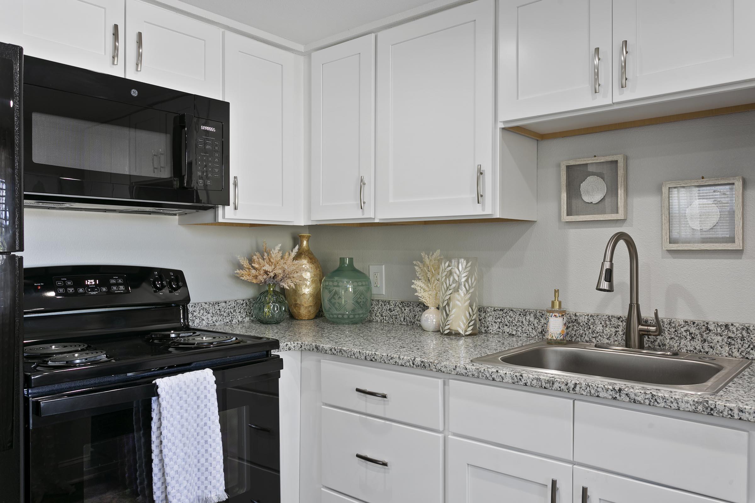 a stove top oven sitting inside of a kitchen