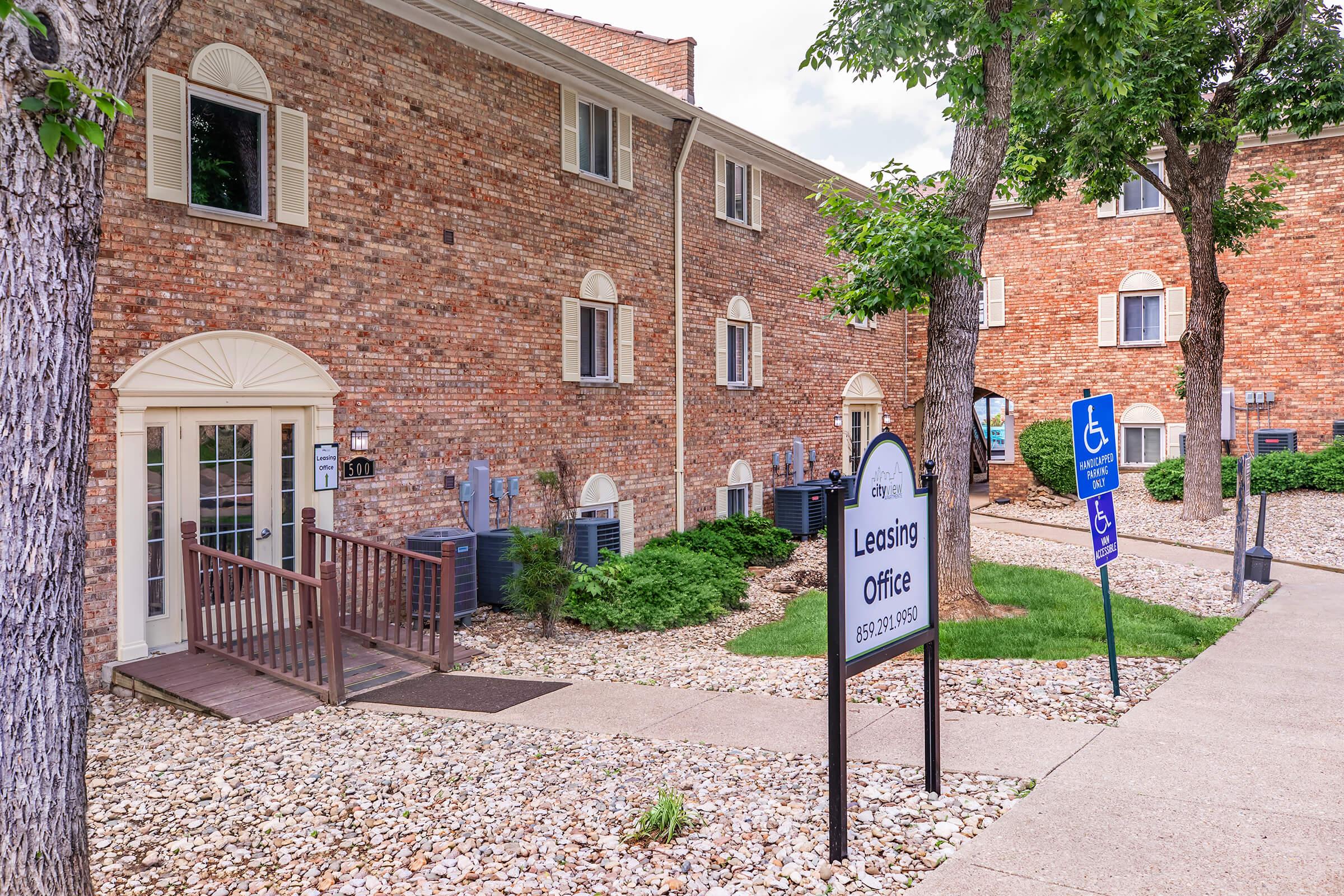 a house that has a sign on a brick building