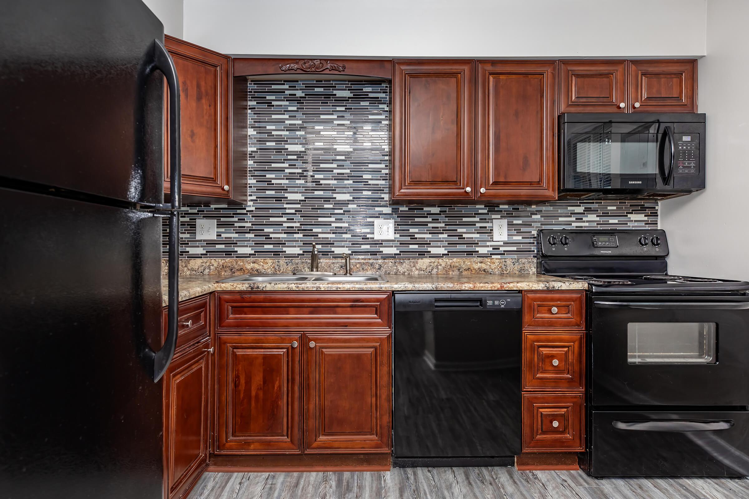 a kitchen with stainless steel appliances and wooden cabinets