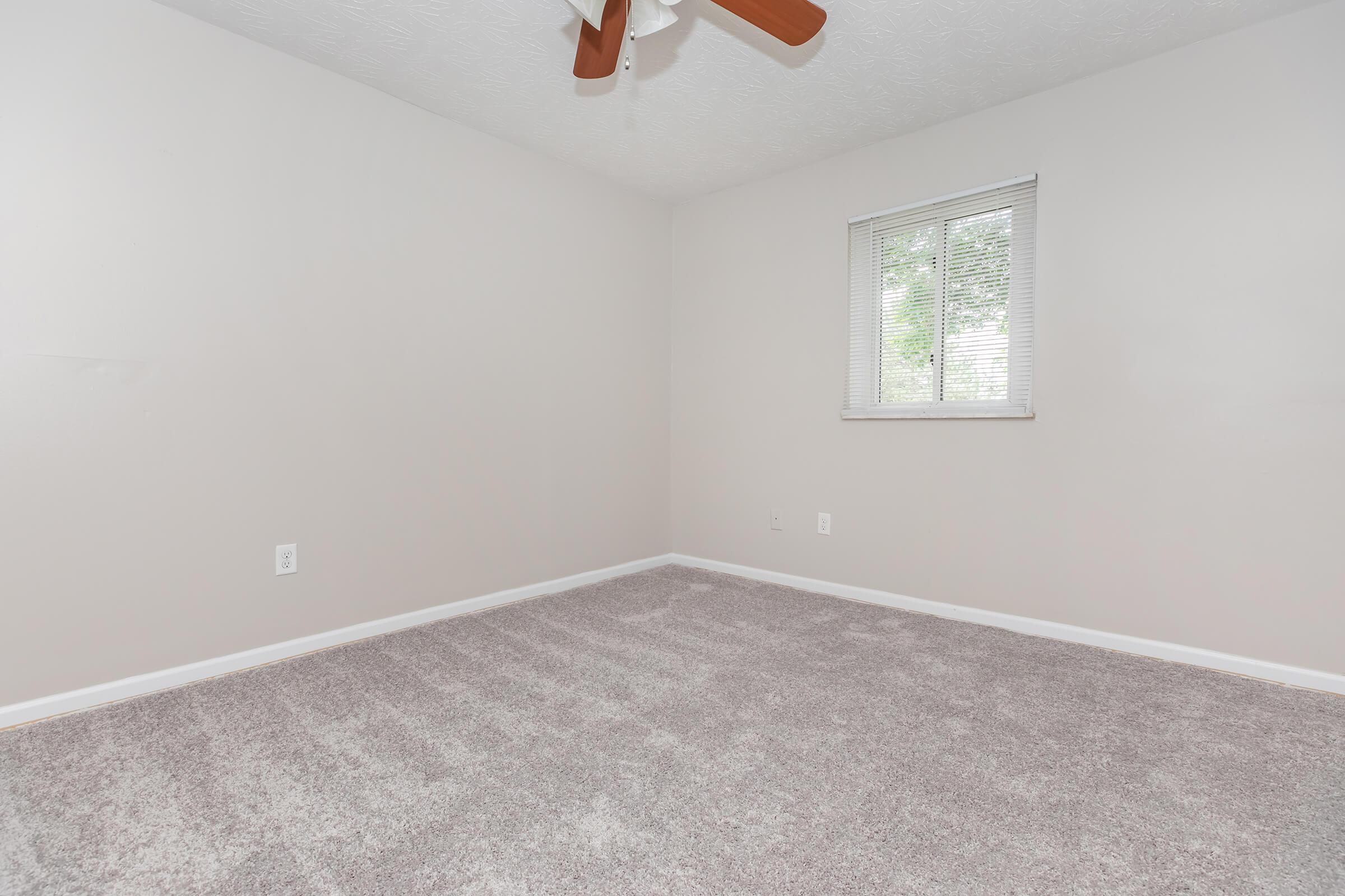 a bedroom with a large window