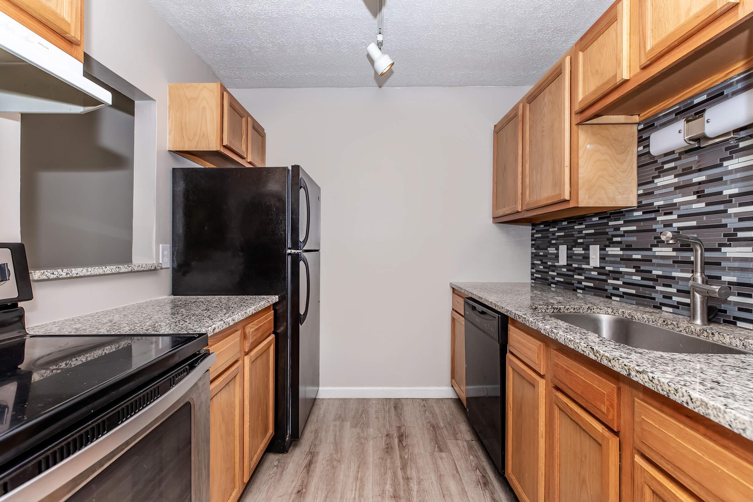 a modern kitchen with stainless steel appliances and wooden cabinets