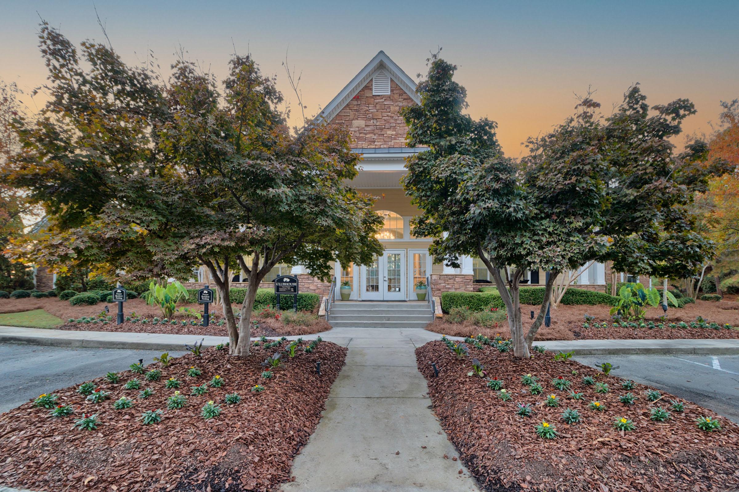 a path with trees on the side of a building