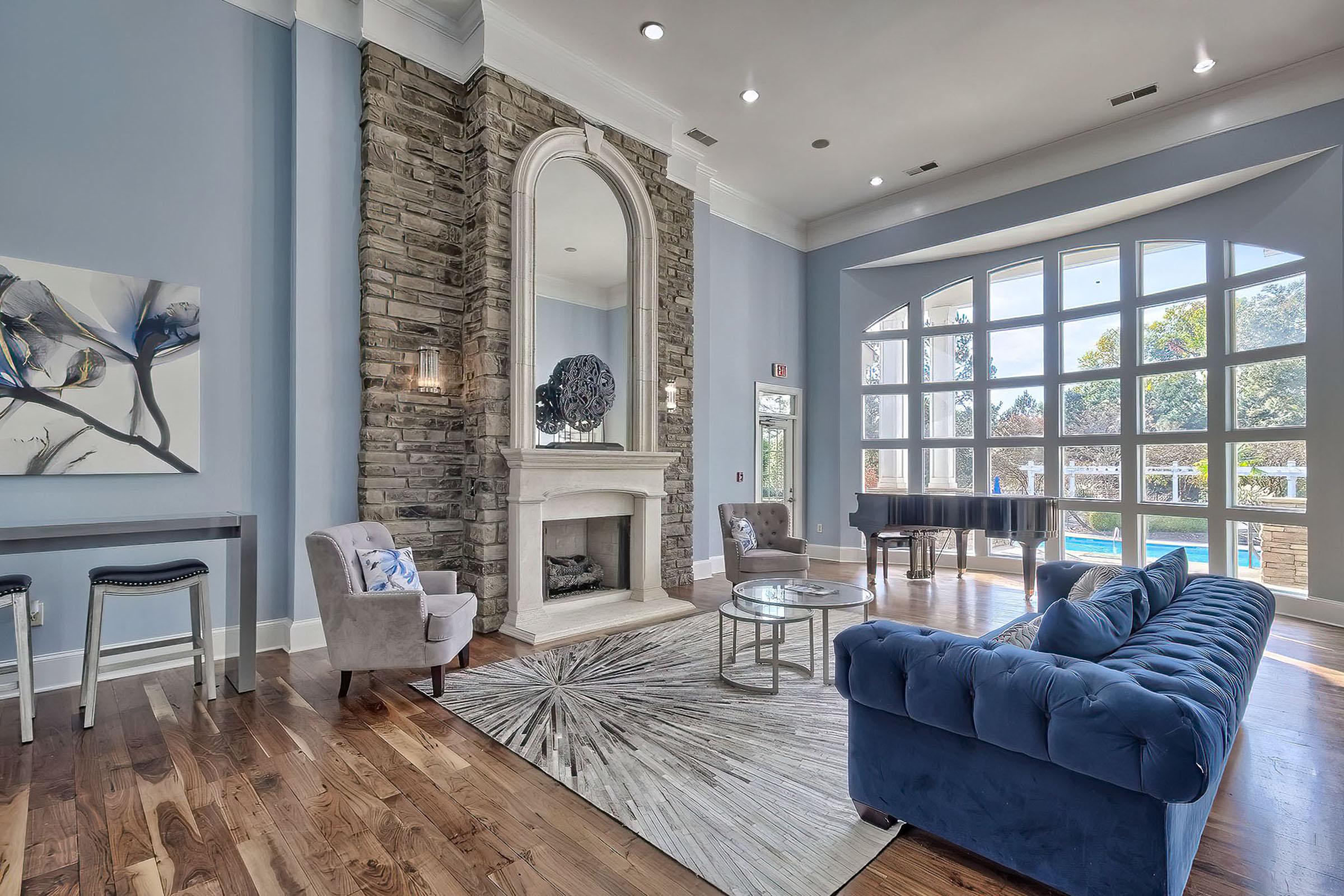 a living room filled with furniture and a large window