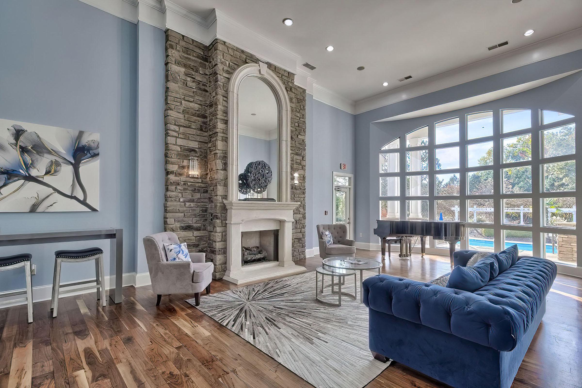 a living room filled with furniture and a large window