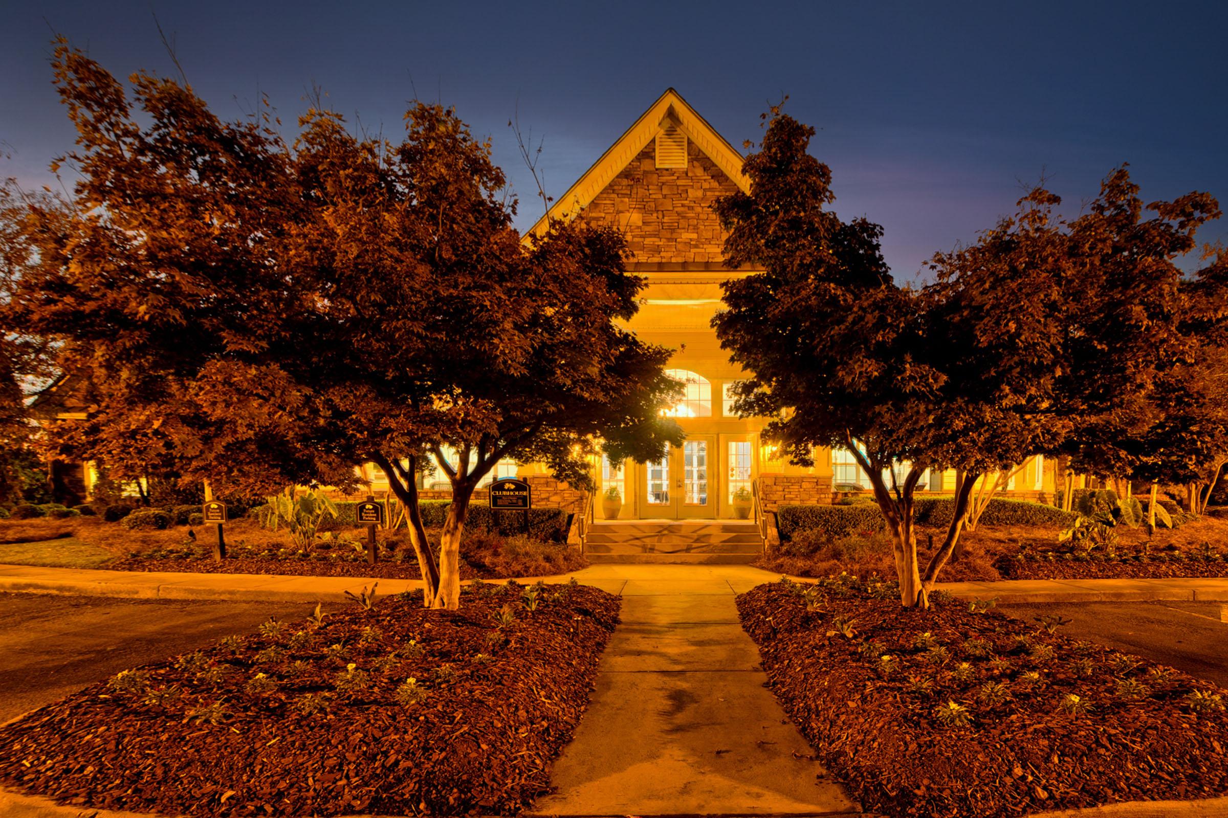 a path with trees on the side of a building