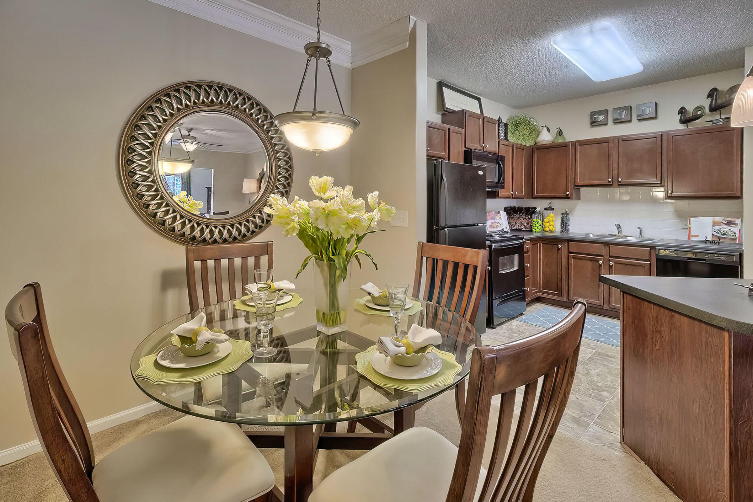 a room filled with furniture and vase of flowers on a table