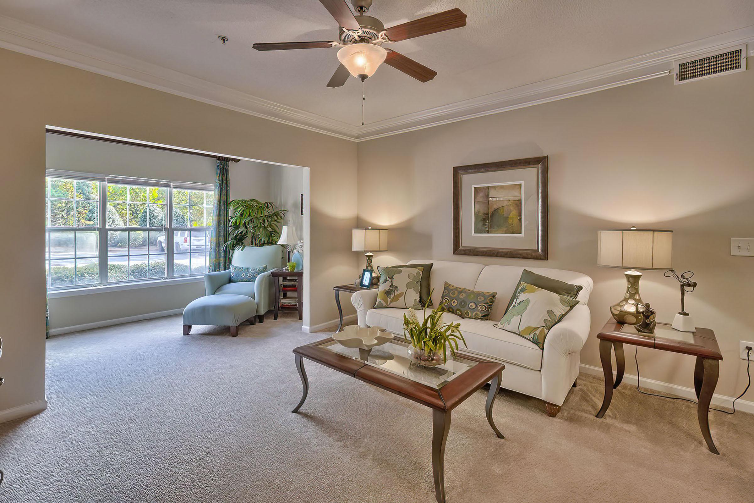 a living room filled with furniture and a large window