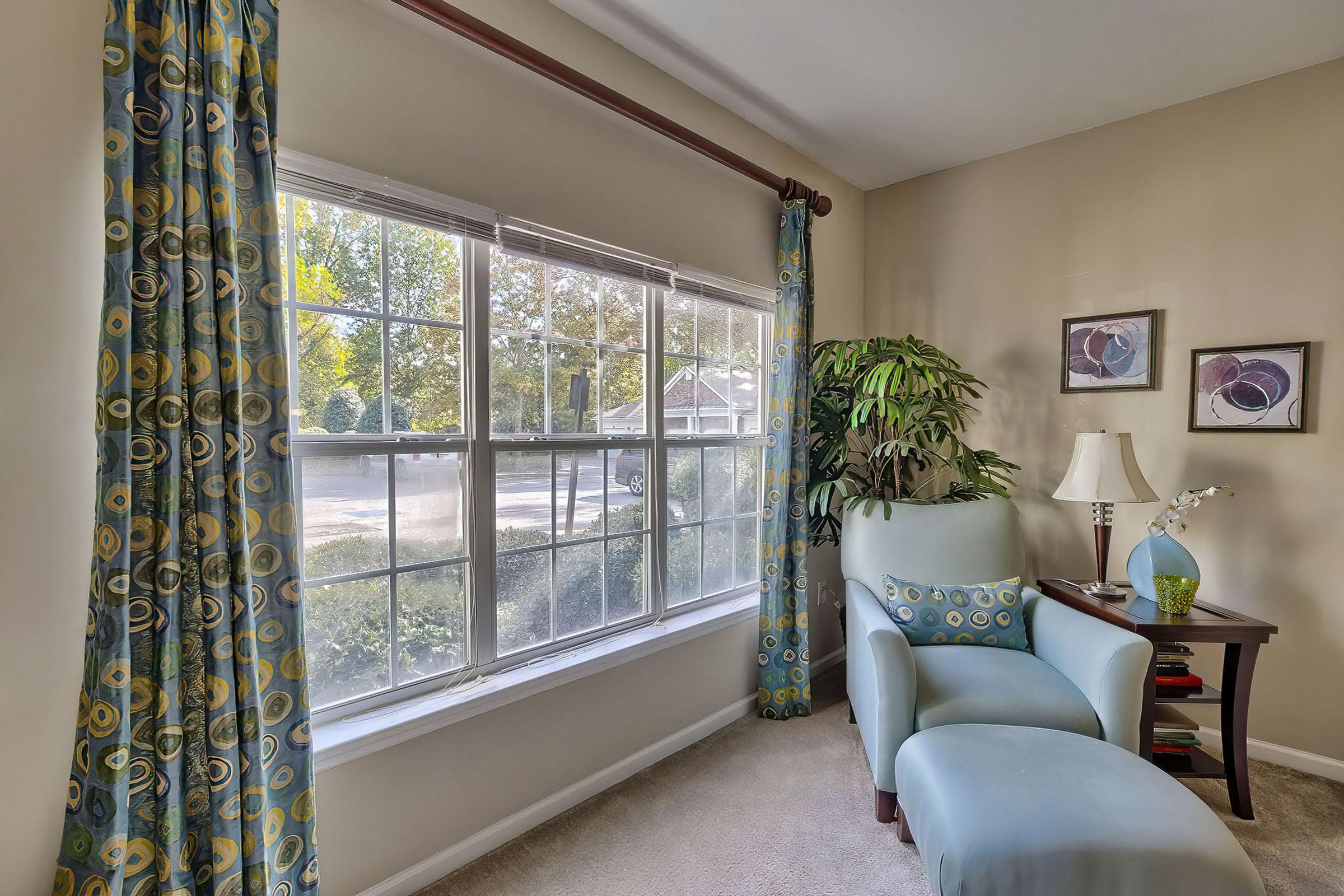 a living room filled with furniture and a large window